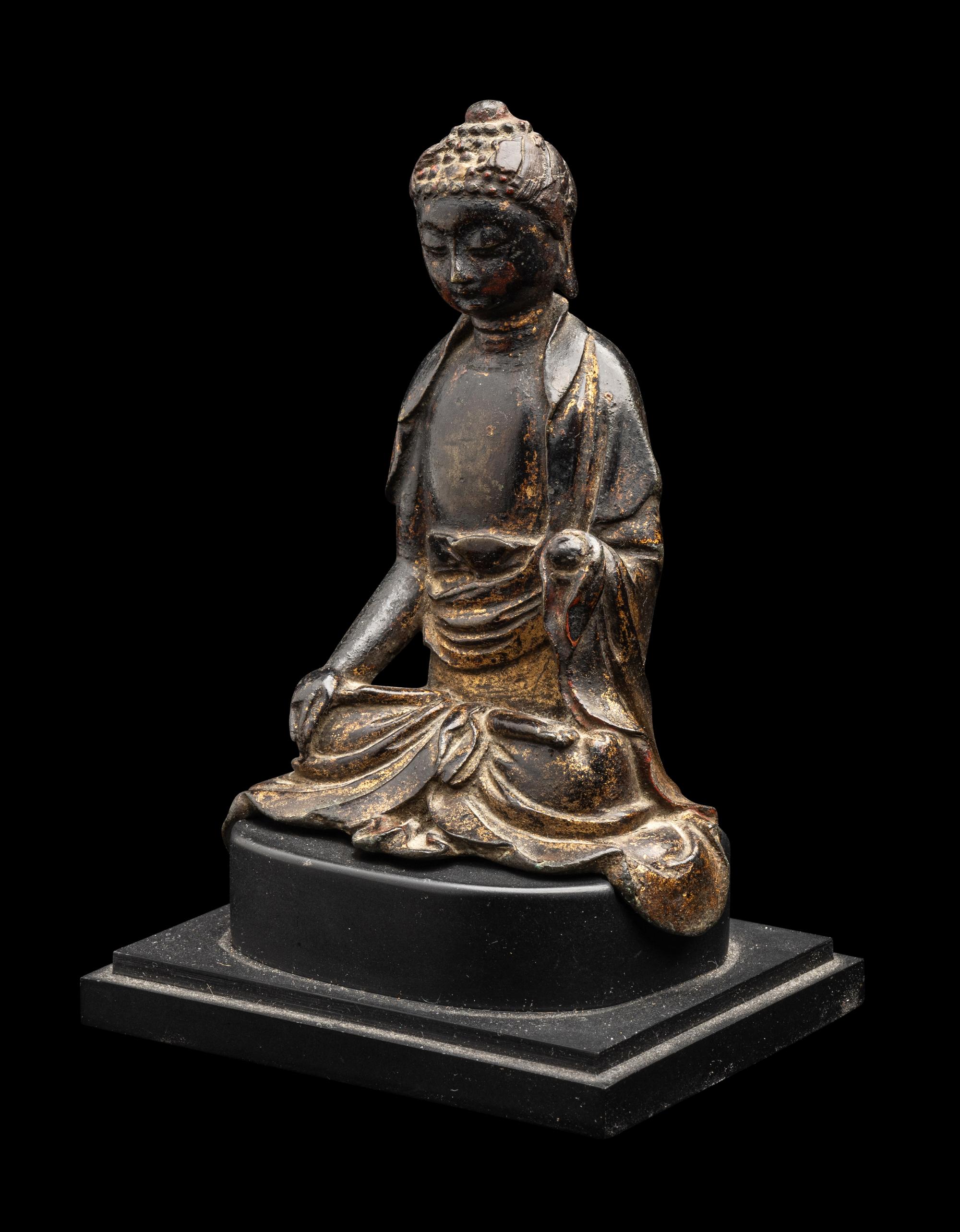 A Chinese Parcel-Gilt Bronze Figure of Buddha Shakyamuni, Ming Dynasty or Earlier 明或更早 銅局部鎏金坐佛