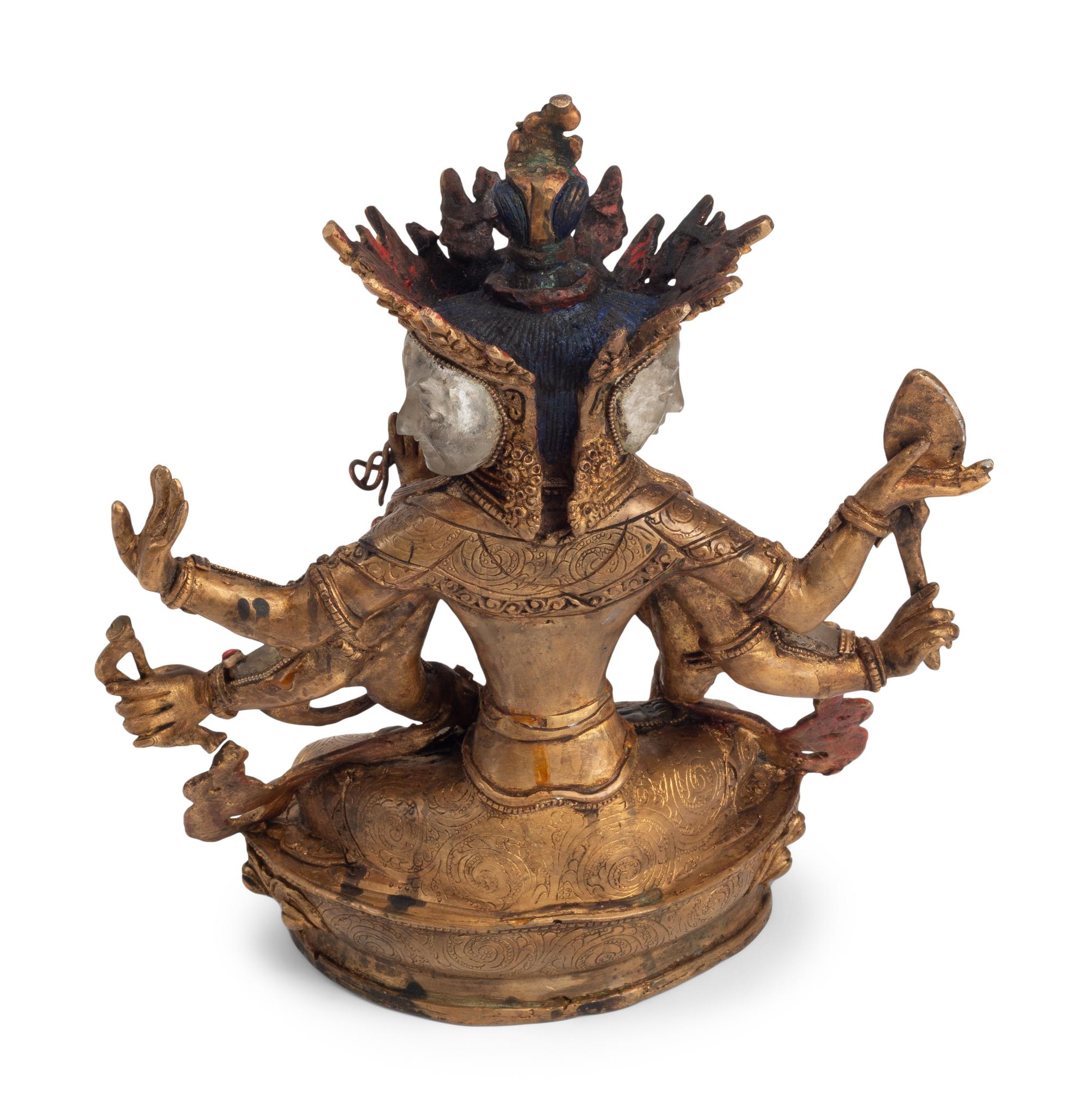 A Tibetan Style Gilt Bronze, Rock Crystal and Cabochon-Inset Figure of a Deity