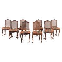 A Set of Eight French Carved Walnut and Caned Dining Chairs