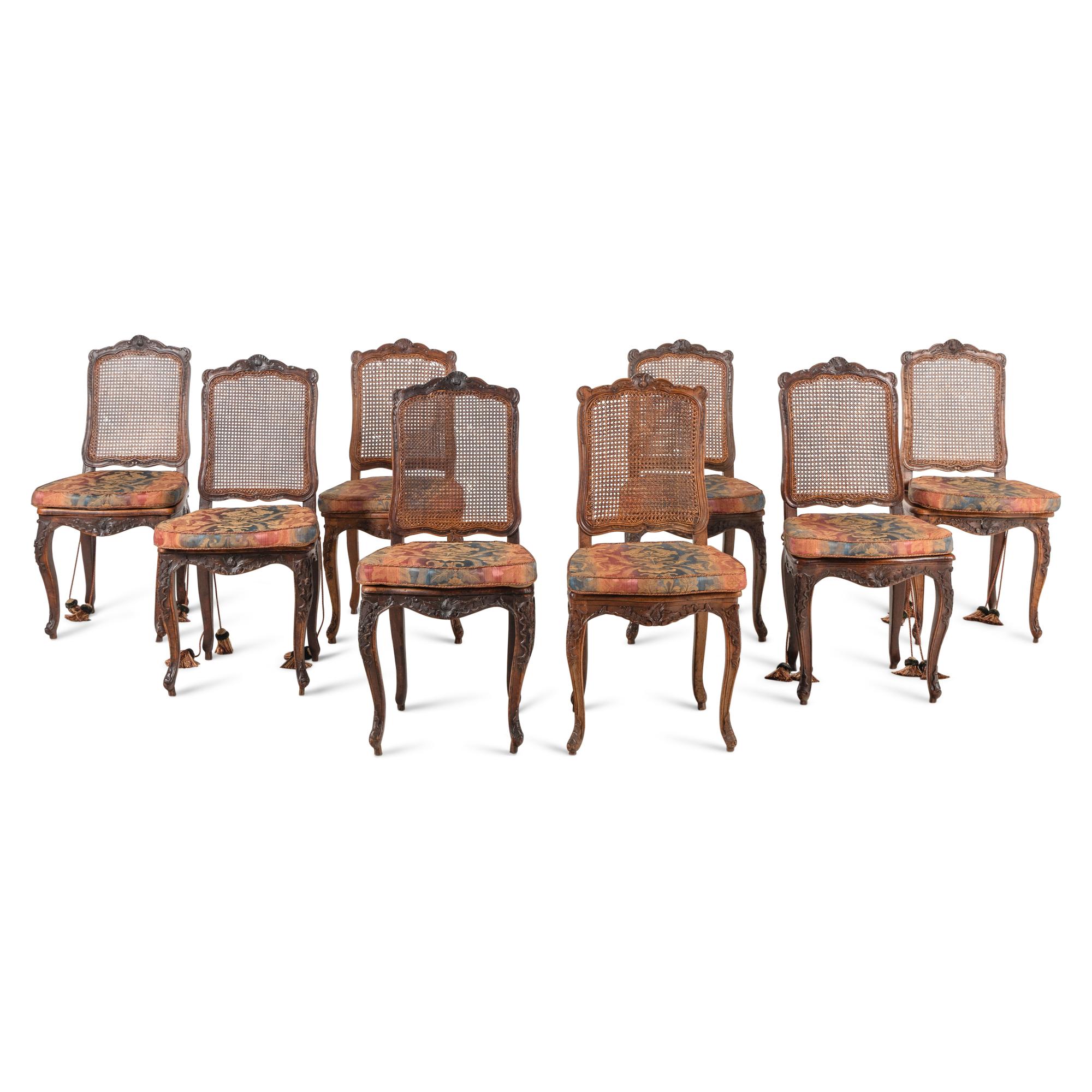 A Set of Eight French Carved Walnut and Caned Dining Chairs