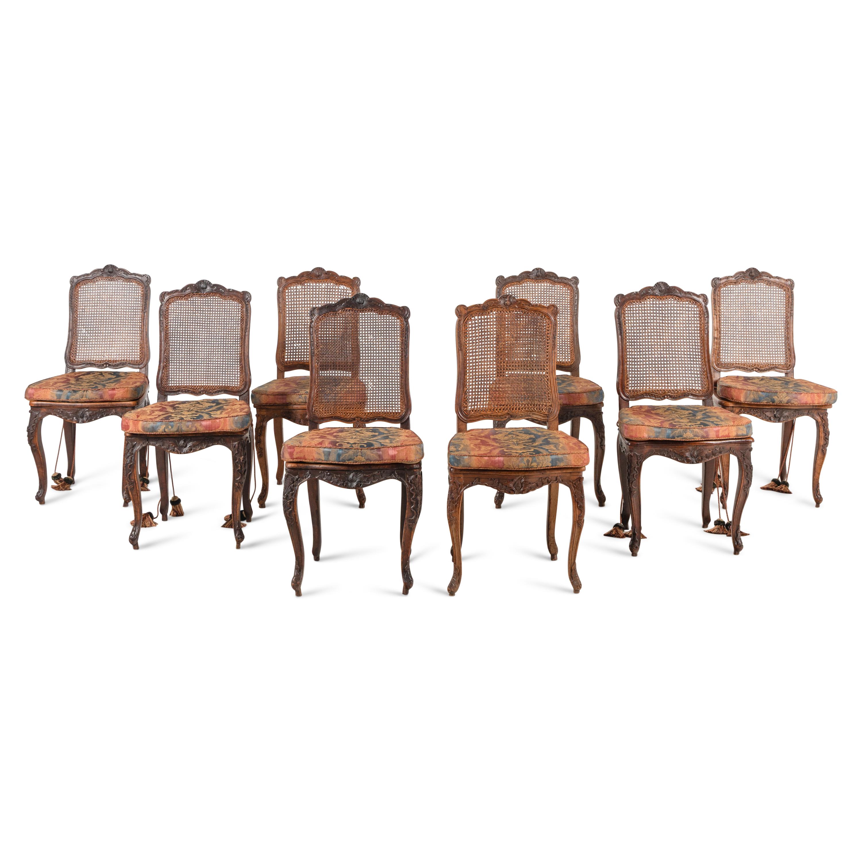 A Set of Eight French Carved Walnut and Caned Dining Chairs