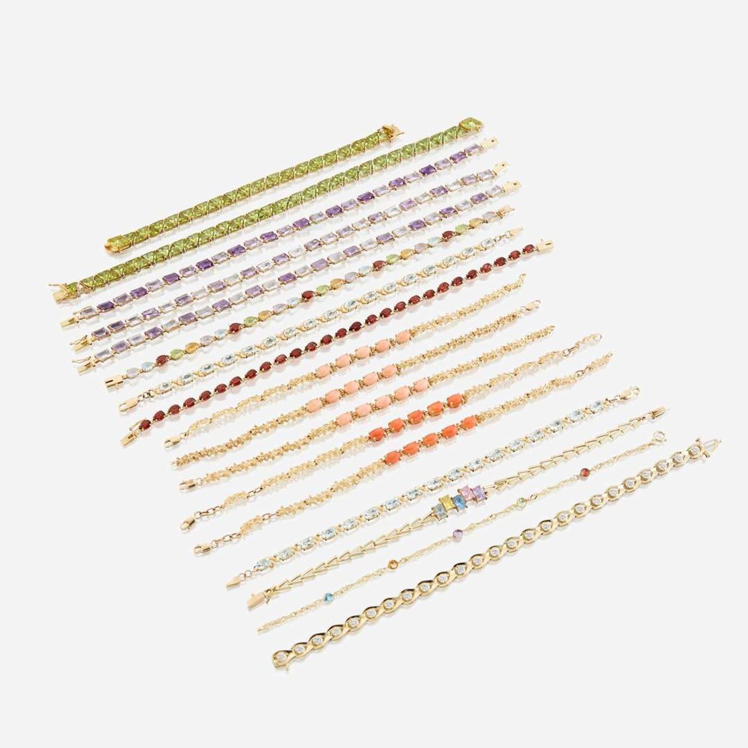 A collection of seventeen fourteen karat gold and gem-set bracelets