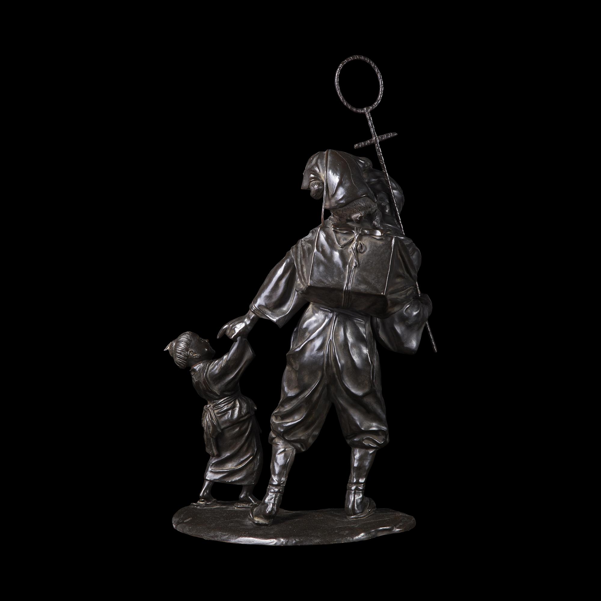 A Japanese Tokyo School Patinated Bronze Monkey Trainer Figural Group, Meiji/Taisho Period