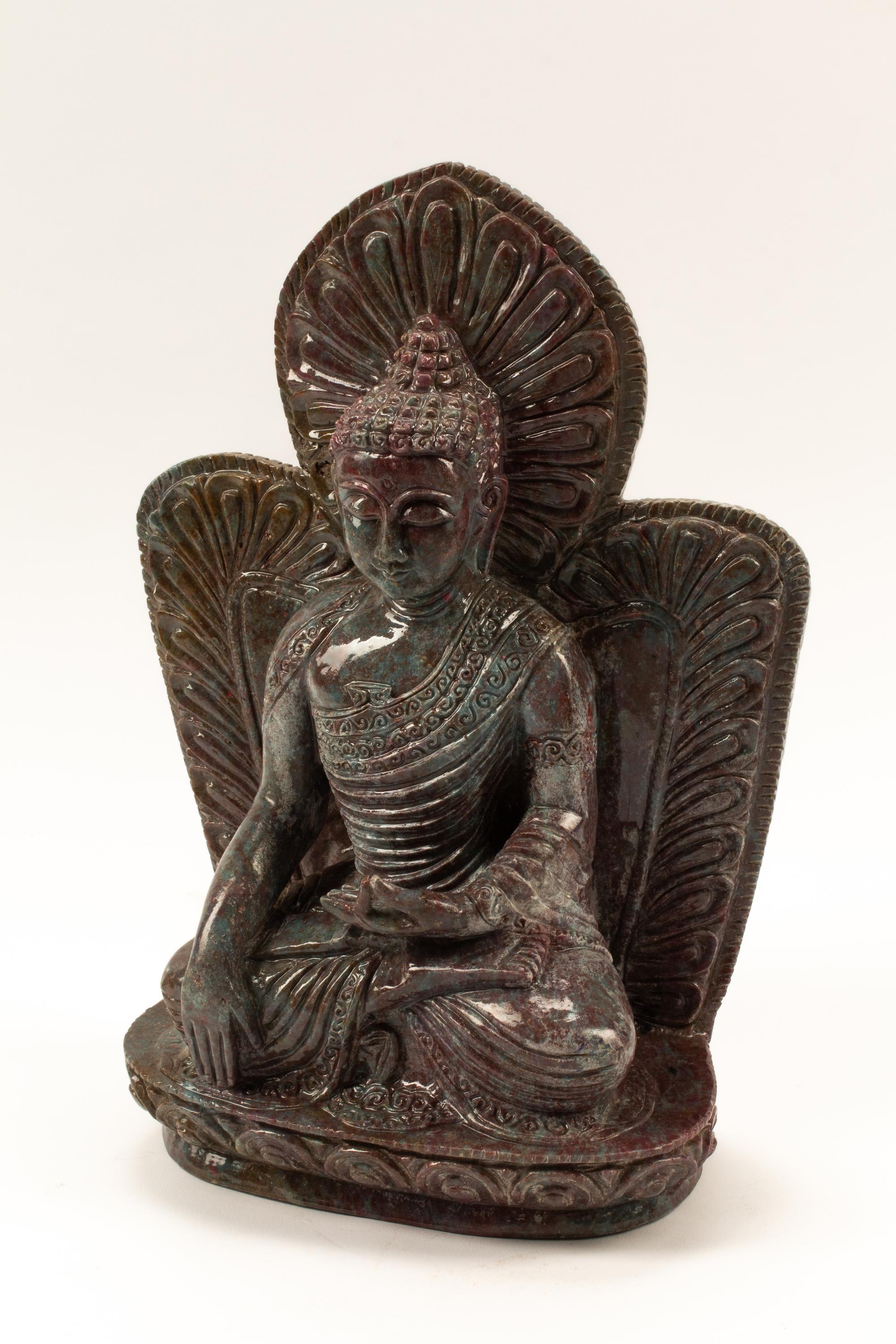 A Carved Ruby-Zoisite Figure of a Seated Deity