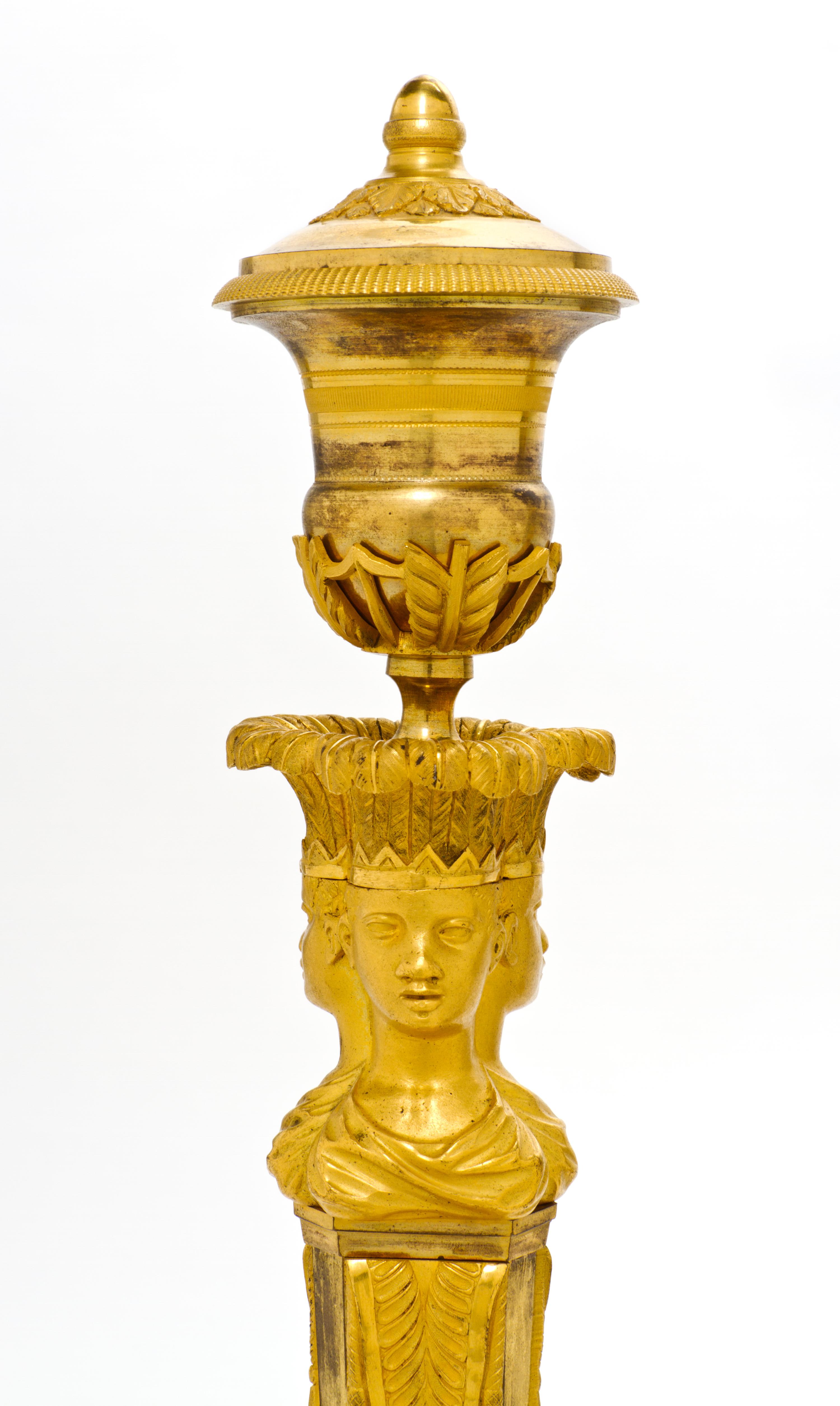A Pair of Empire Gilt Bronze Candlesticks, EARLY 19TH CENTURY, Height 13 3/4 inches. — EARLY 19TH CENTURY,