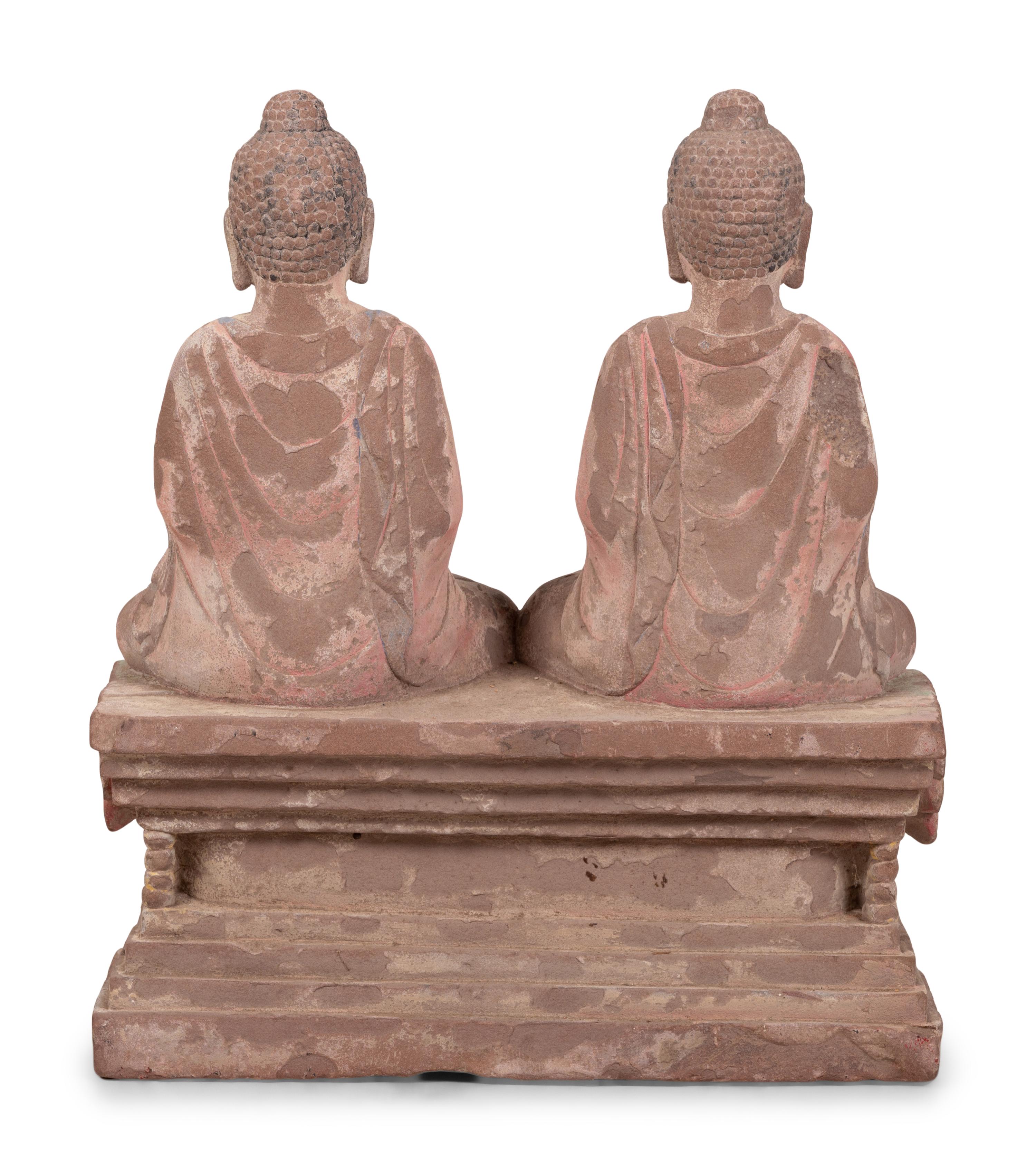Two Chinese Carved Stone Seated Figures on a Rectangular Base with Remnants of Polychrome Decoration