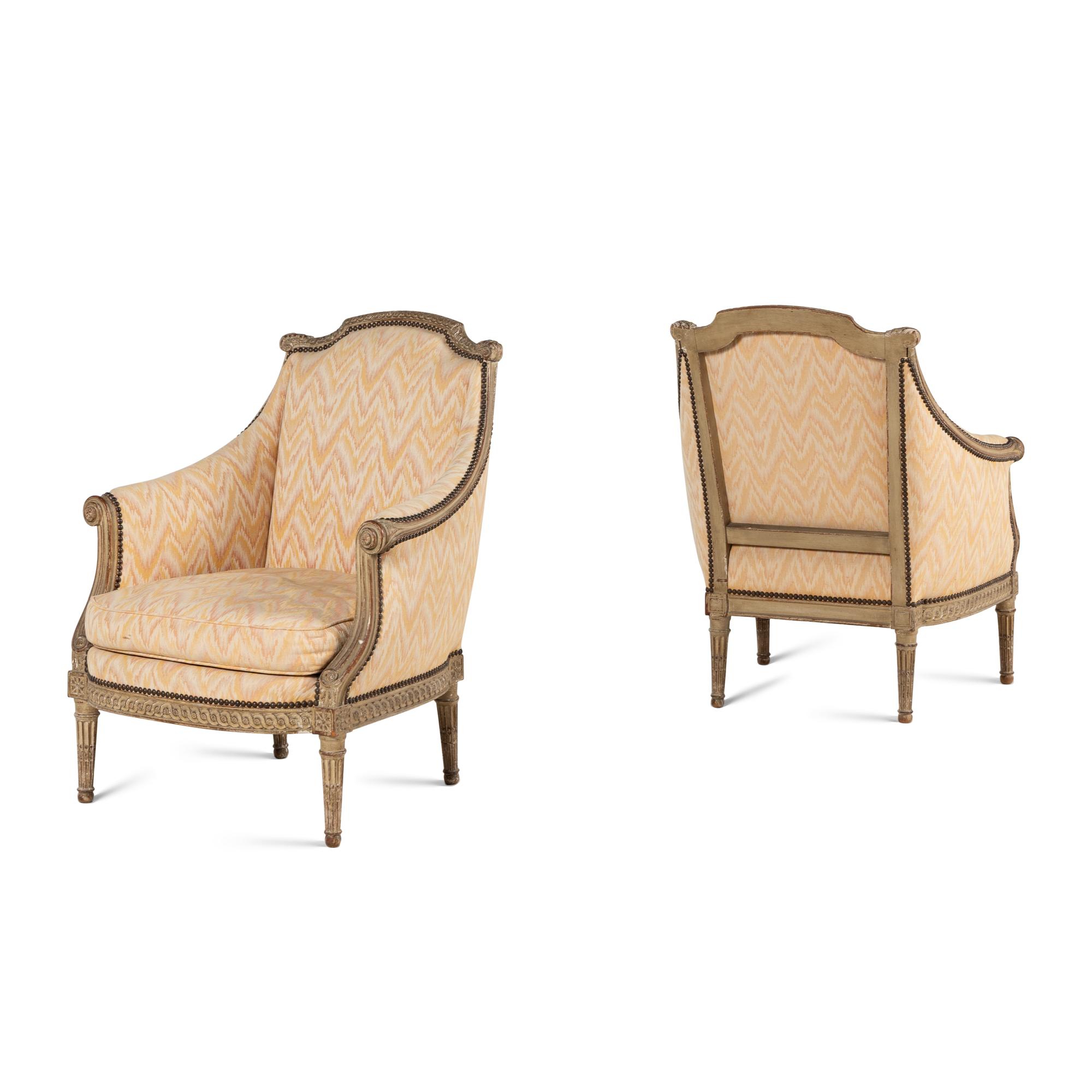 A Pair of Louis XVI Style Carved and Grey-Painted Bergères