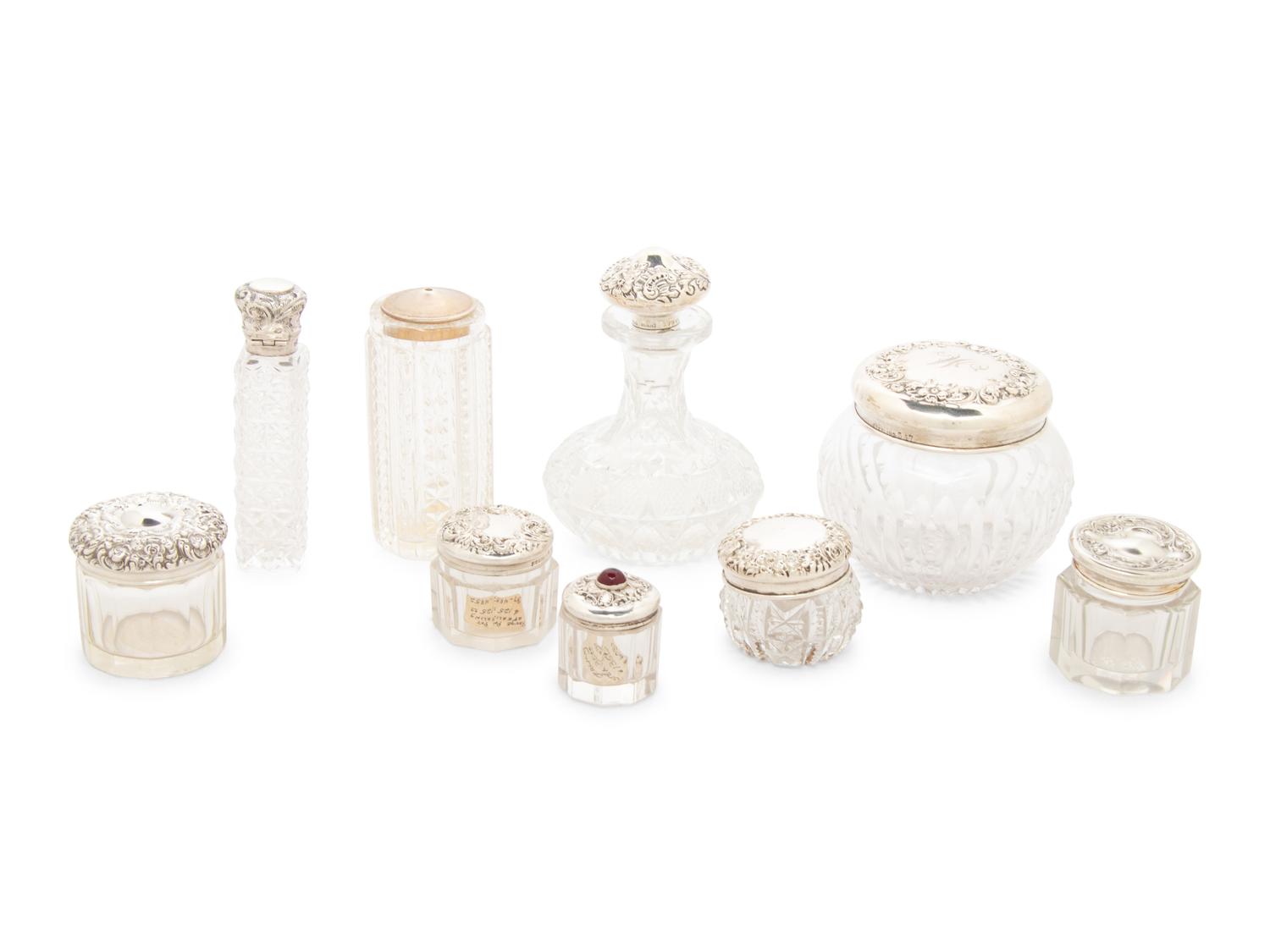 A Collection of Silver Mounted Glass Scent Bottles and Vanity Jars