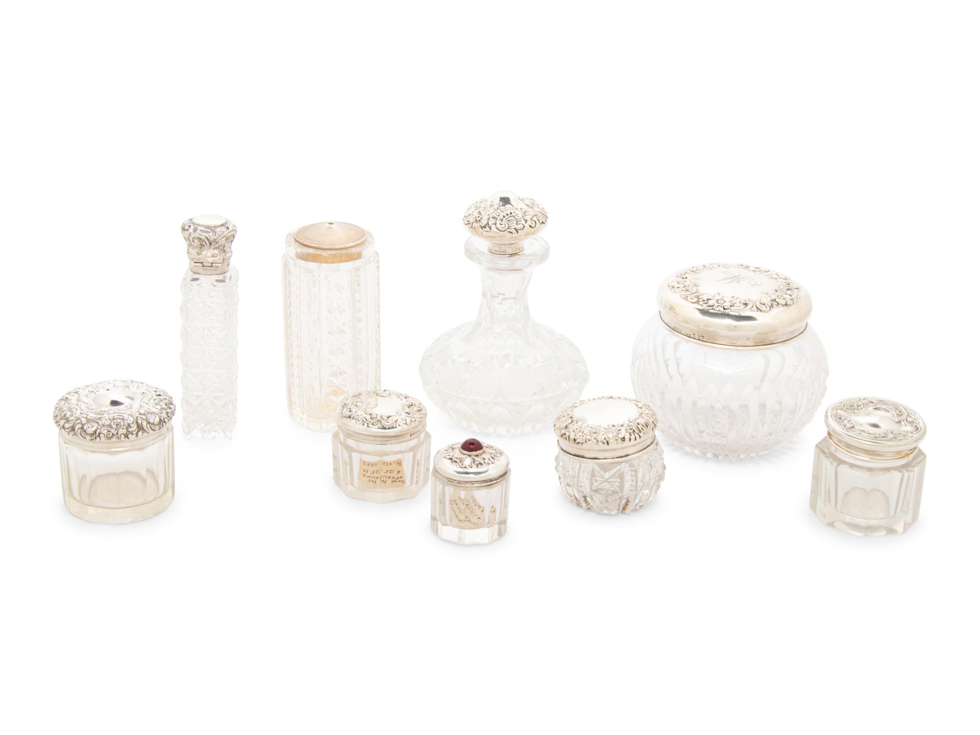 A Collection of Silver Mounted Glass Scent Bottles and Vanity Jars