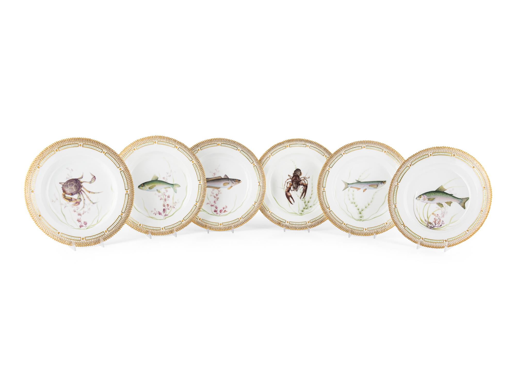A Set of Twelve Royal Copenhagen Parcel Gilt Porcelain Fish Plates