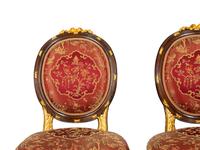 A Pair of Louis XVI Style Stained and Gilt Mahogany Side Chairs.
