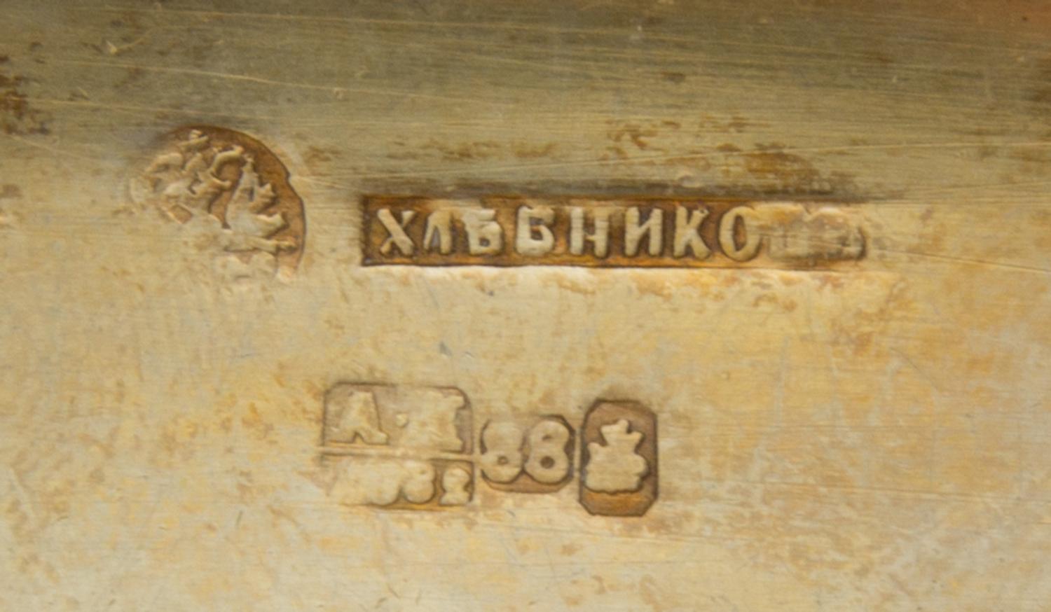 A Russian Enameled Silver Cigarette Case, Mark of Ivan Khlebnikov with imperial warrant, Moscow, 1882, the case worked with foliate and