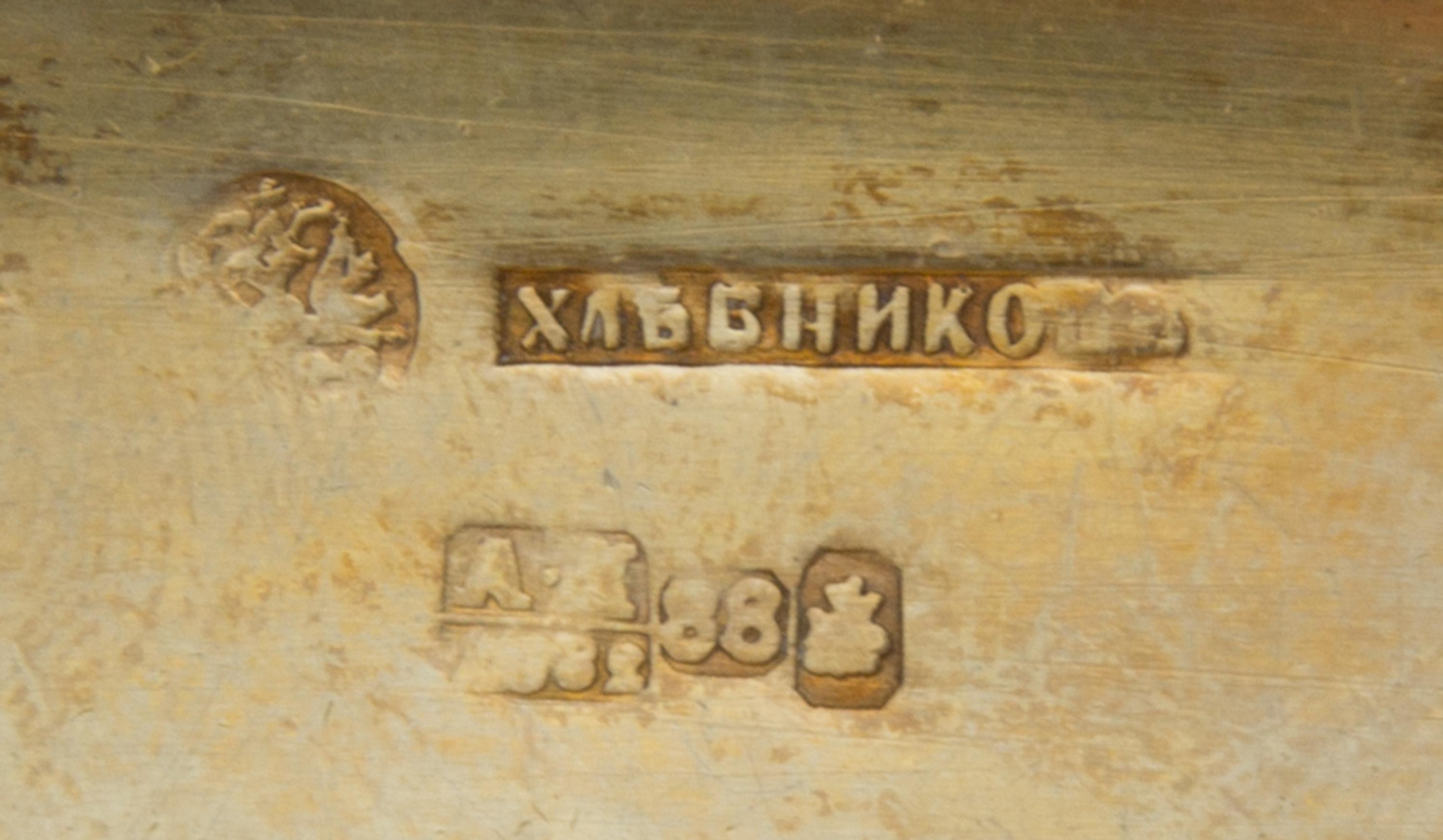 A Russian Enameled Silver Cigarette Case, Mark of Ivan Khlebnikov with imperial warrant, Moscow, 1882, the case worked with foliate and