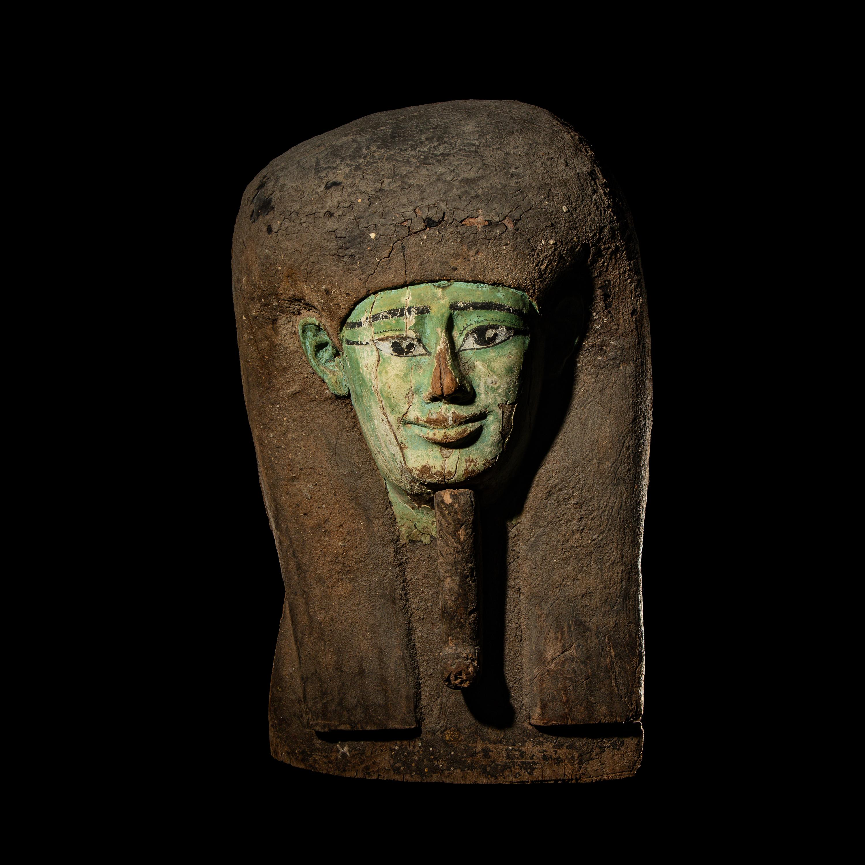 An Egyptian Painted Wood Sarcophagus Head