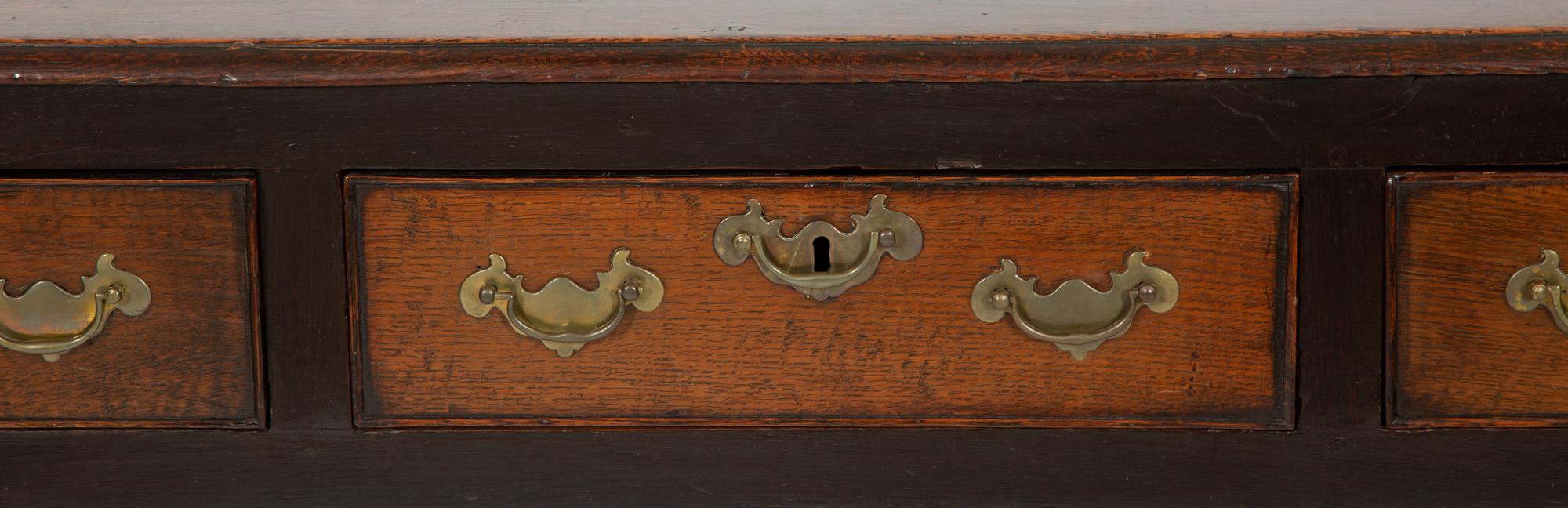 A Queen Anne Oak Three Drawer Sideboard