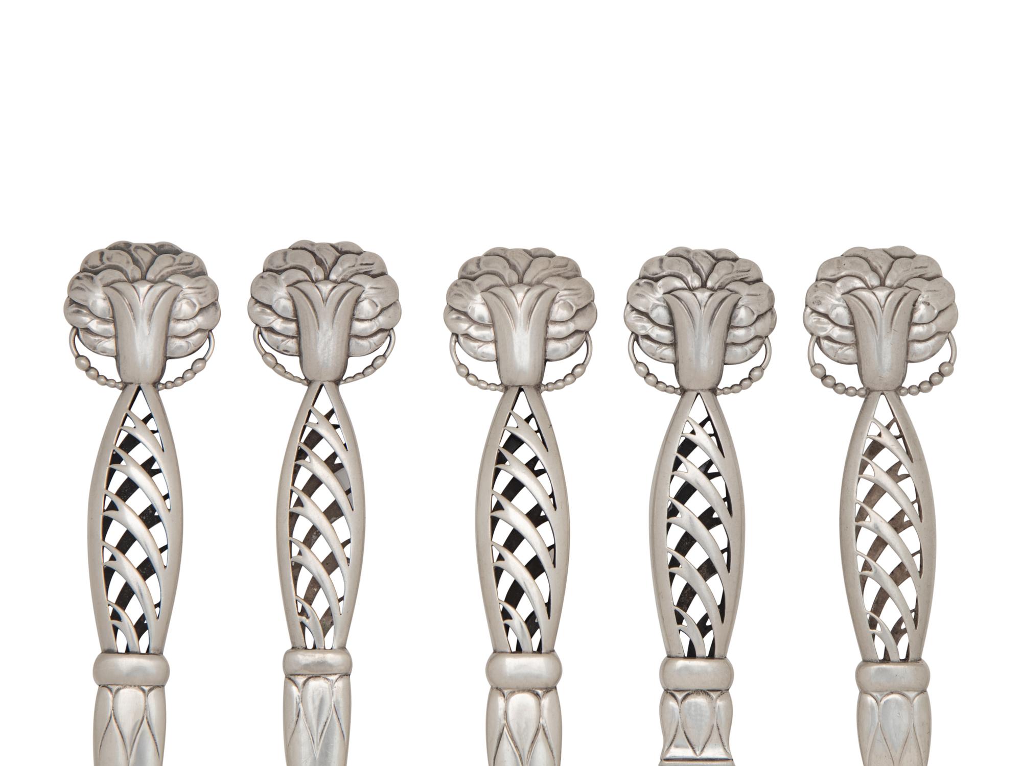 A Group of Eight Georg Jensen Silver Ornamental Serving Articles