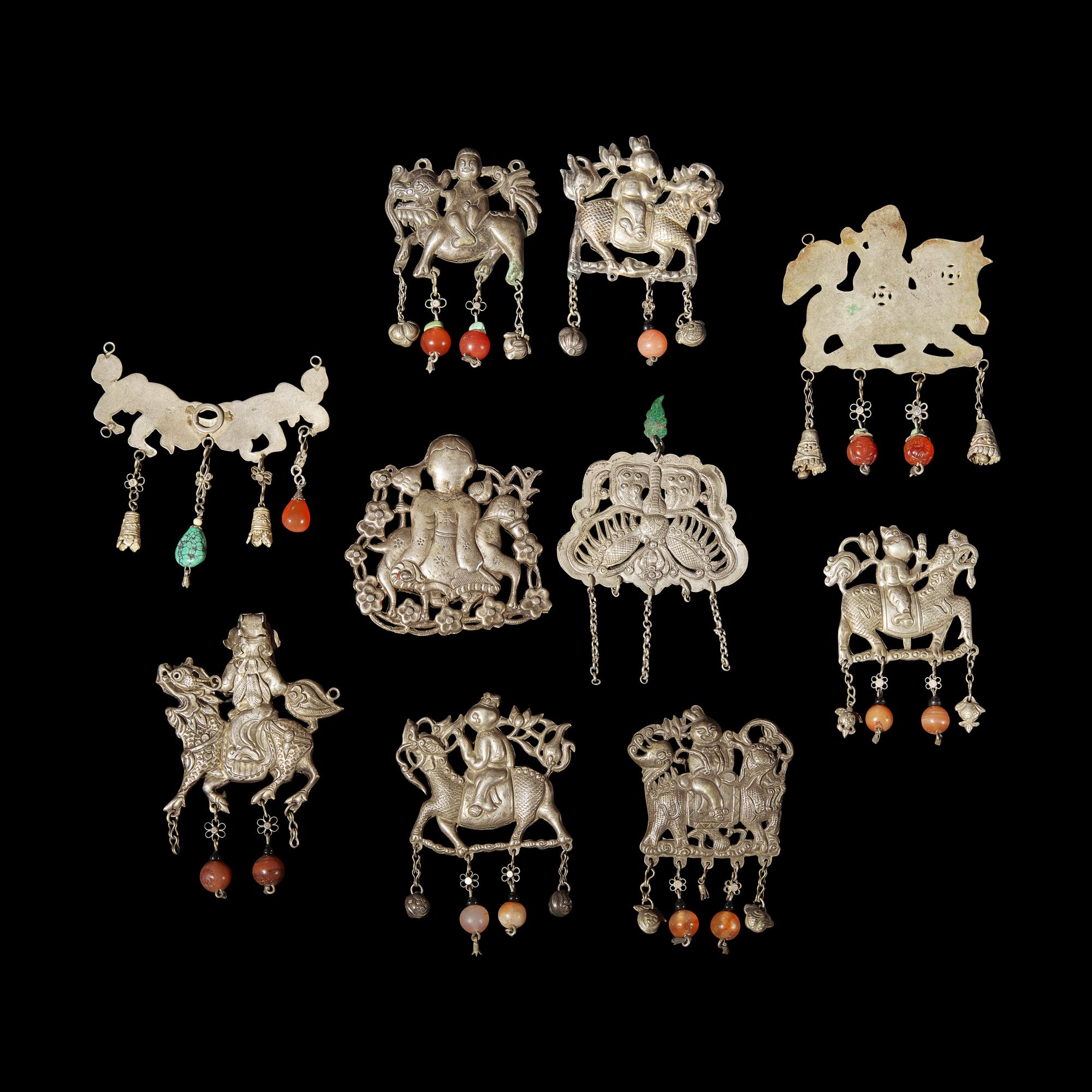 A Group of 10 Assorted Chinese Silver 'Boy and Qilin' Pendants, Late Qing Dynasty-Republic Period 晚清-民國 銀麒麟送子墜瑪瑙長命鎖及其他一組十件