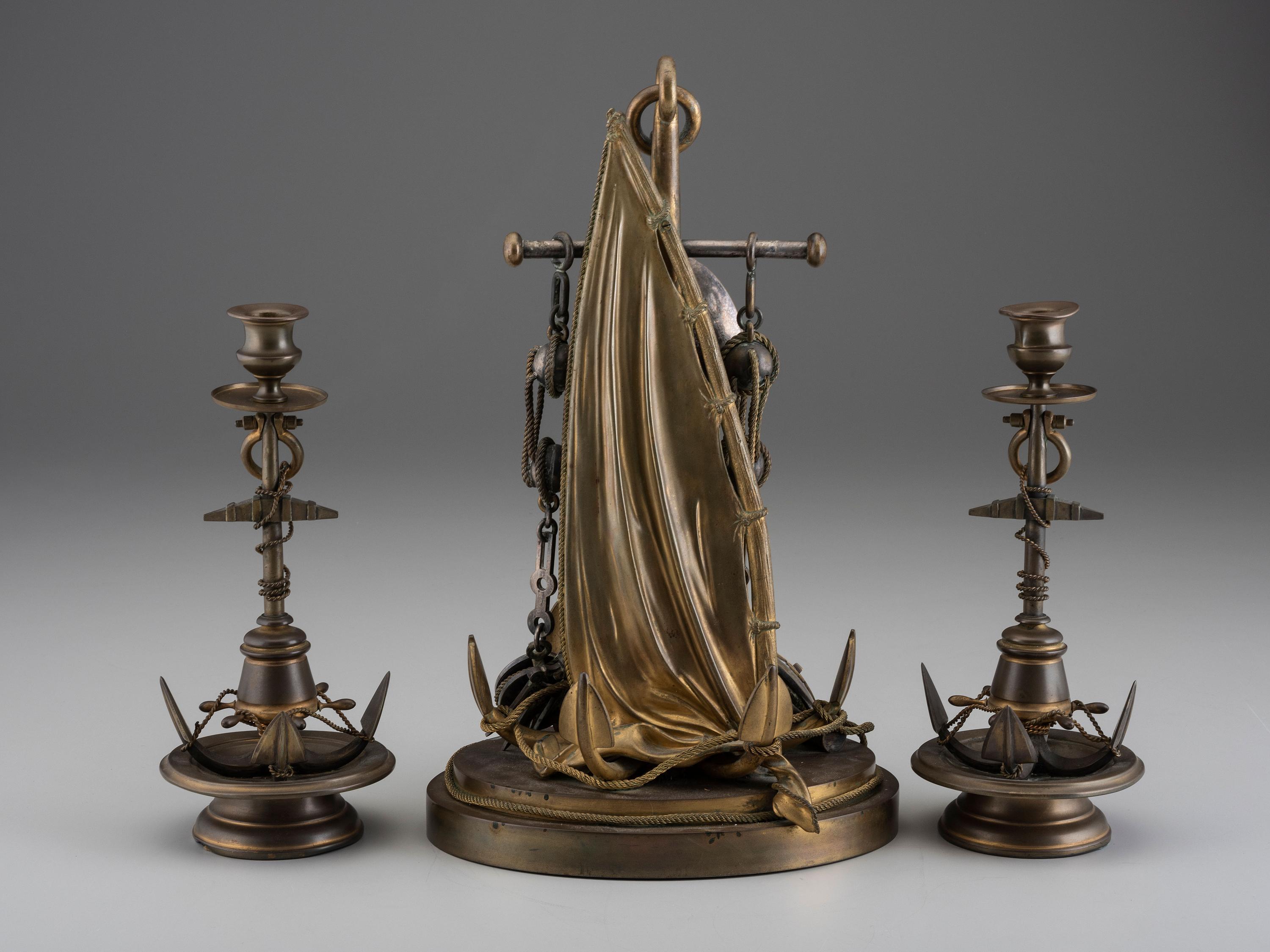 A Cast Brass and Steel Anchor Form Mantel Clock Garniture