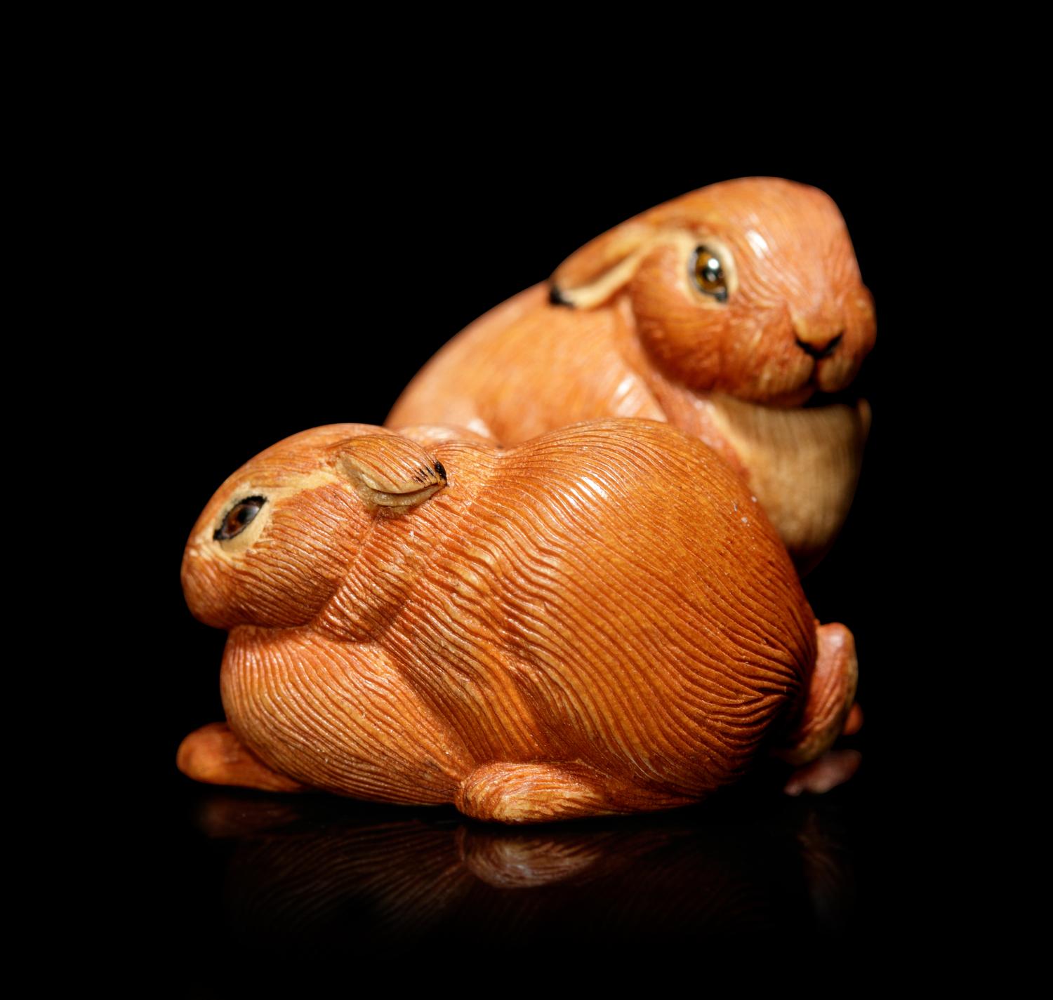 An Amber Inlaid Boxwood 'Leverets' Ojime
