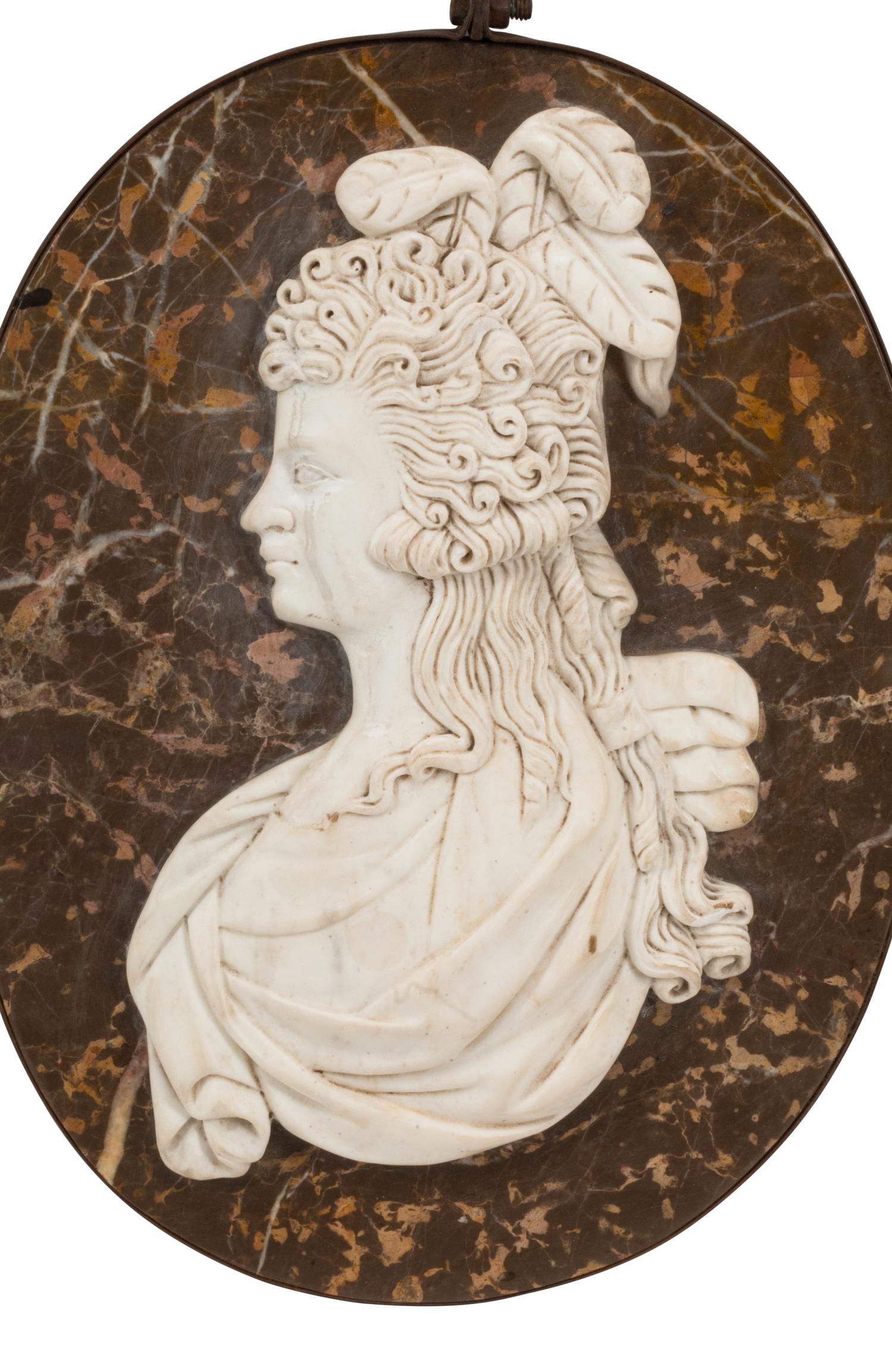 A Set of Four Italian Carved Marble and Iron Mounted Profile Medallions