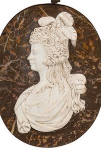 A Set of Four Italian Carved Marble and Iron Mounted Profile Medallions