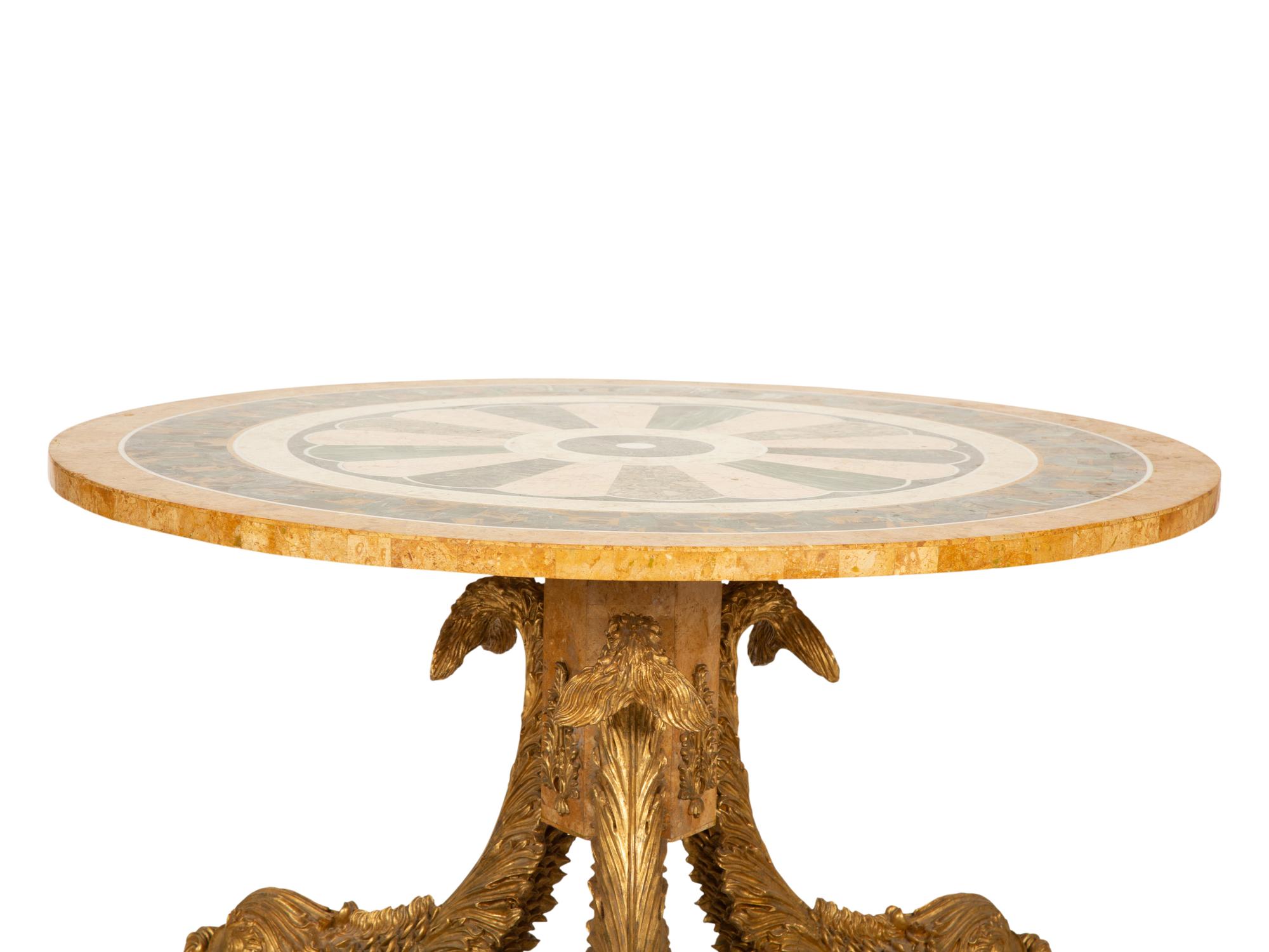 An Italian Design Pietra Dura Center Table with Carved Giltwood Dolphin Base