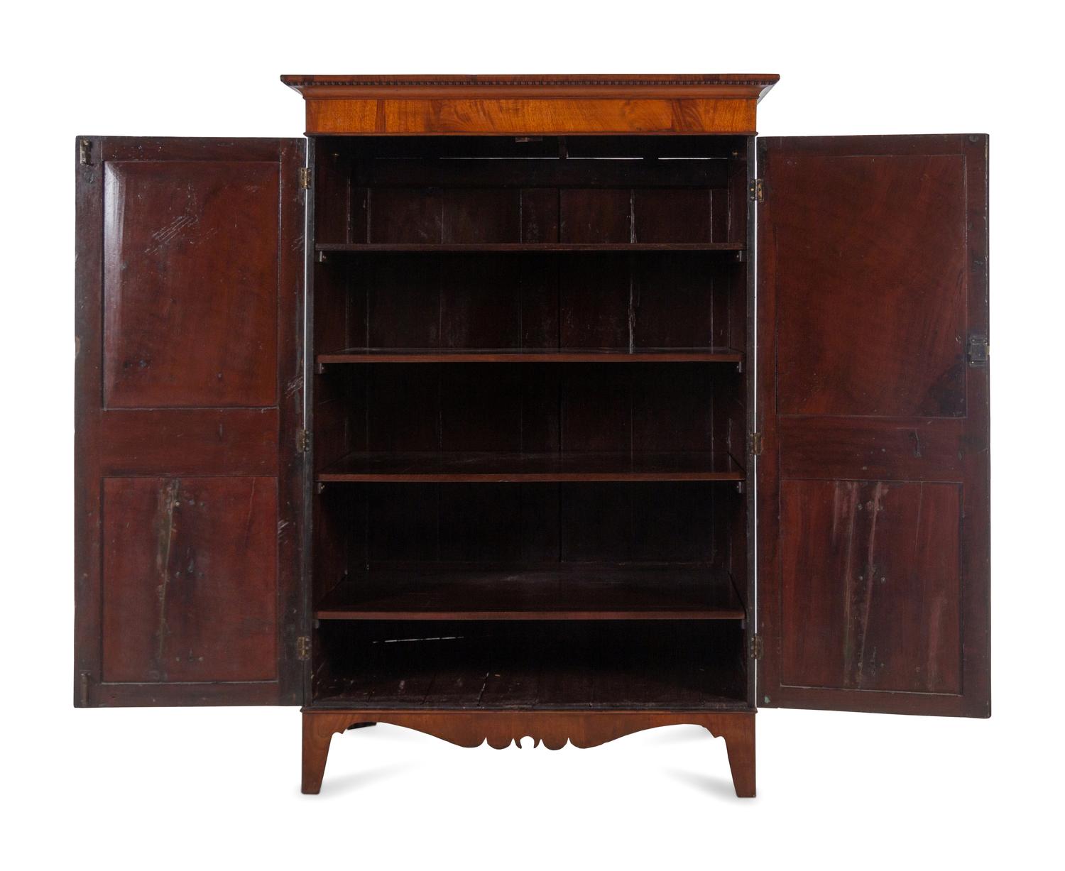 A Regency Mahogany Armoire Simulating a Linen Press