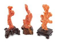 Three Chinese Carved Coral Figures on Wood Stands