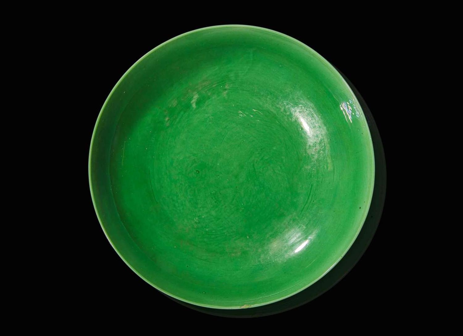 An incised green-glazed "Bajixiang" dish, Yongzheng six-character mark and of the period 暗刻“八吉祥”綠釉盤 雍正六字款 清雍正