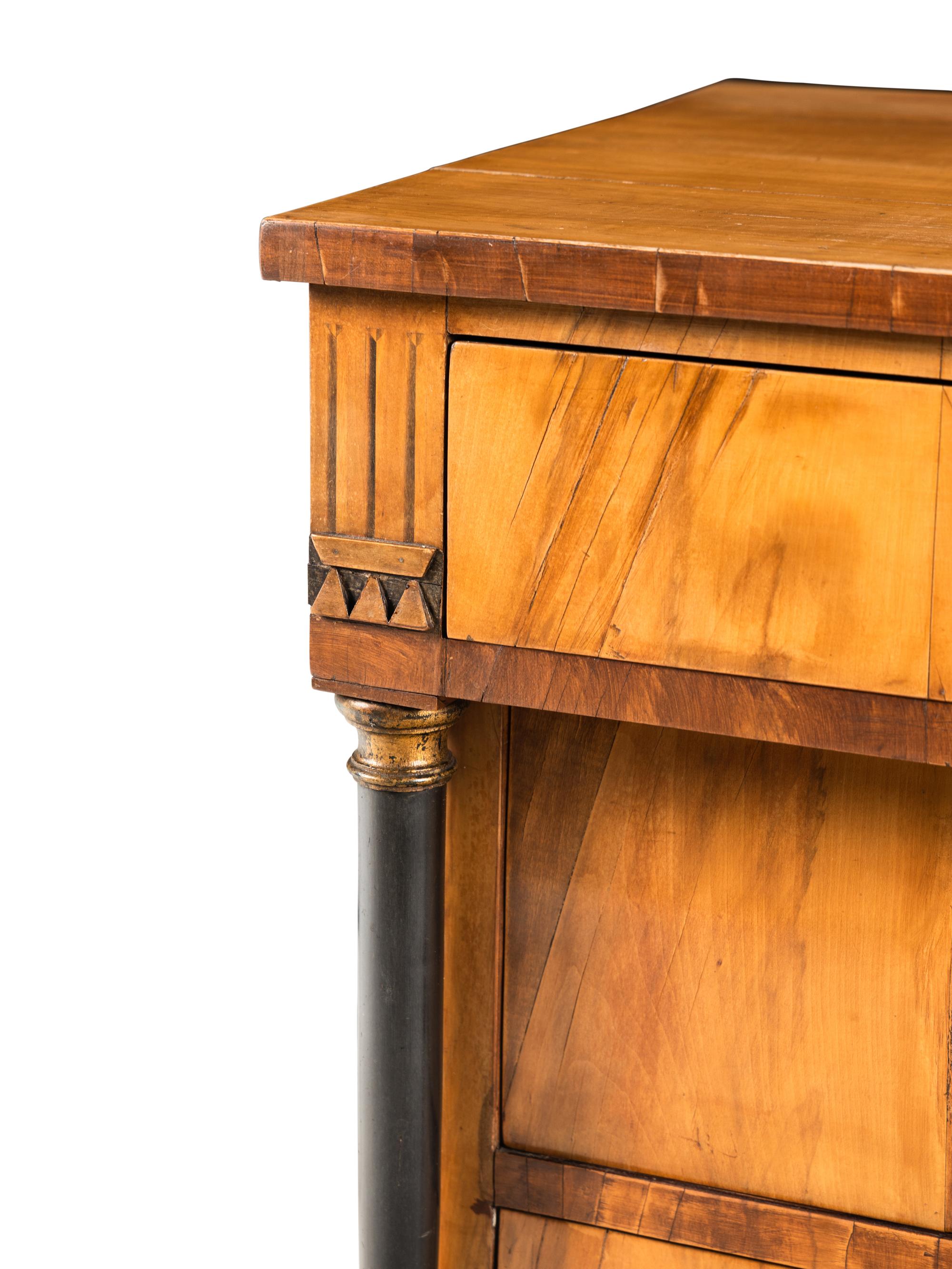 A Biedermeier Walnut and Parcel Ebonized Commode