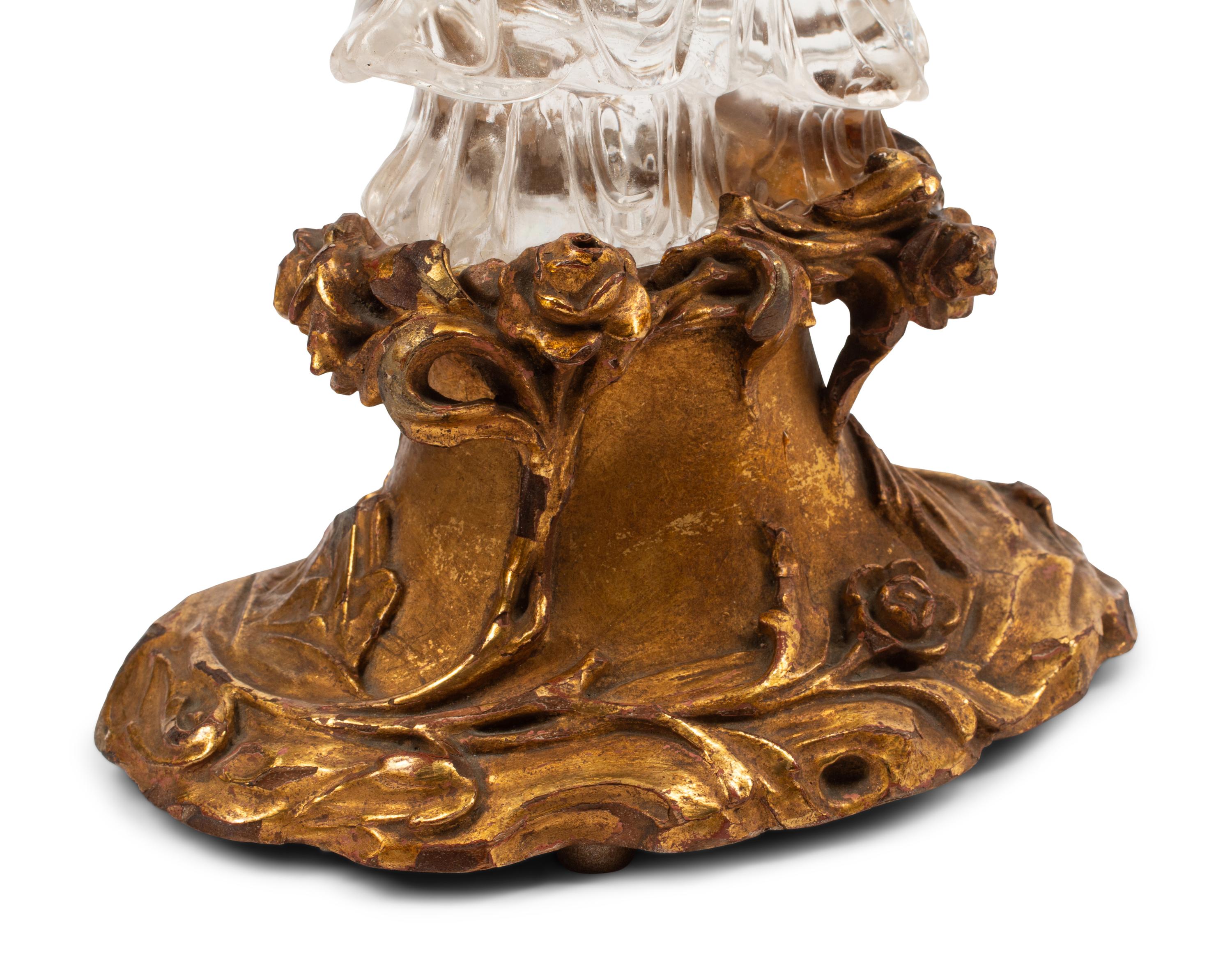 A Carved Rock Crystal Figure of Guanyin on a Giltwood Base