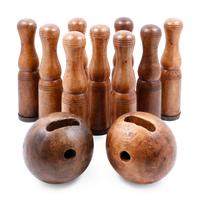A Group of Carved Wood Bowling Pins and Balls