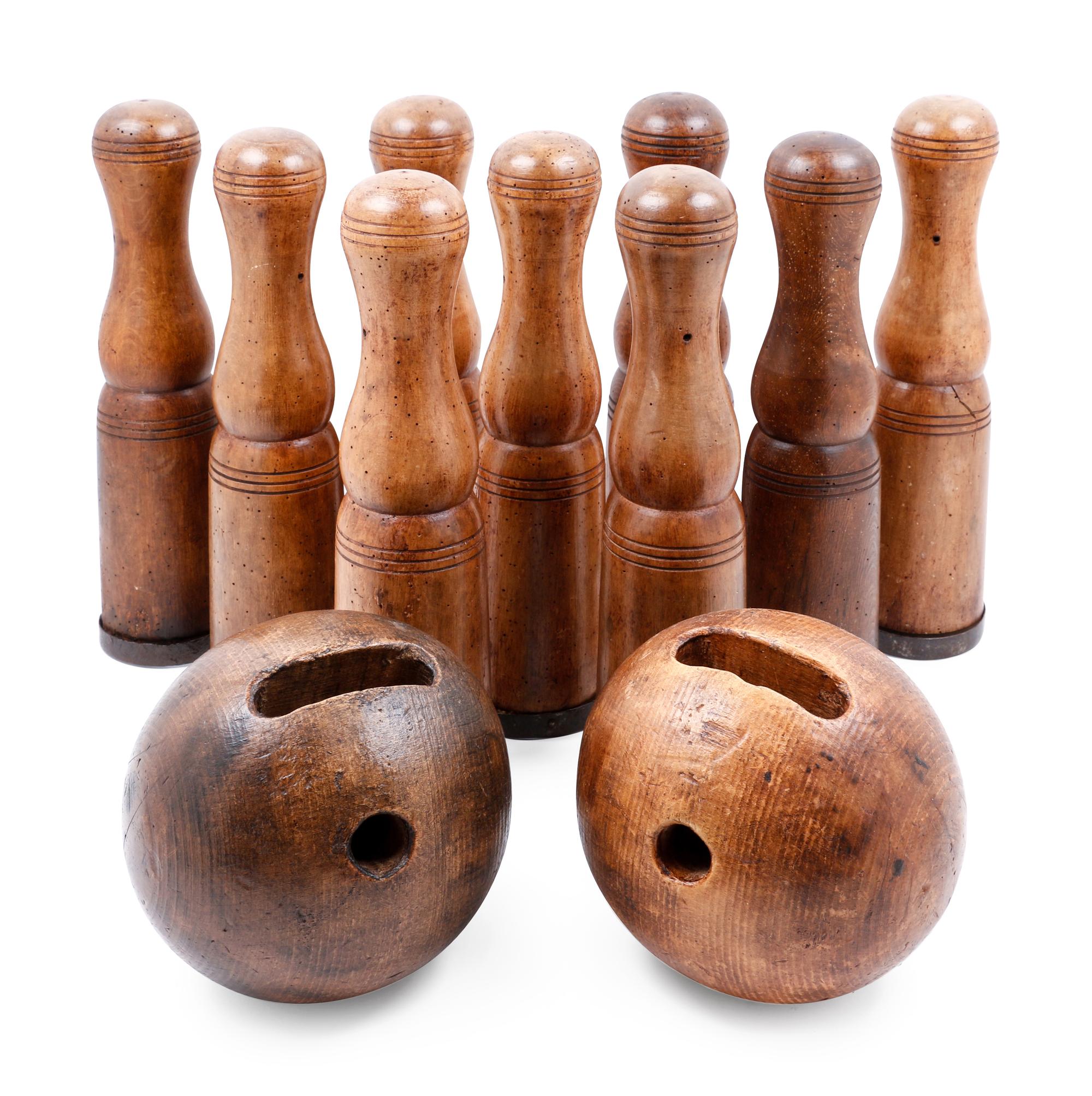 A Group of Carved Wood Bowling Pins and Balls