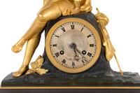 A Charles X Patinated and Gilt Bronze Figural Mantel Clock