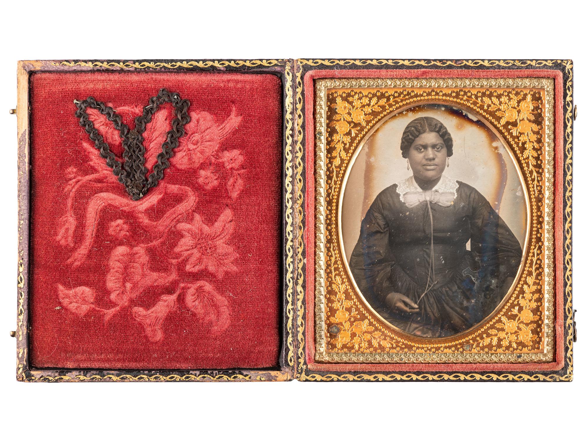 [EARLY PHOTOGRAPHY-AFRICAN AMERICANA]. Sixth plate daguerreotype portrait of subject identified as "Grandma Binx" with braided hairwork heart.