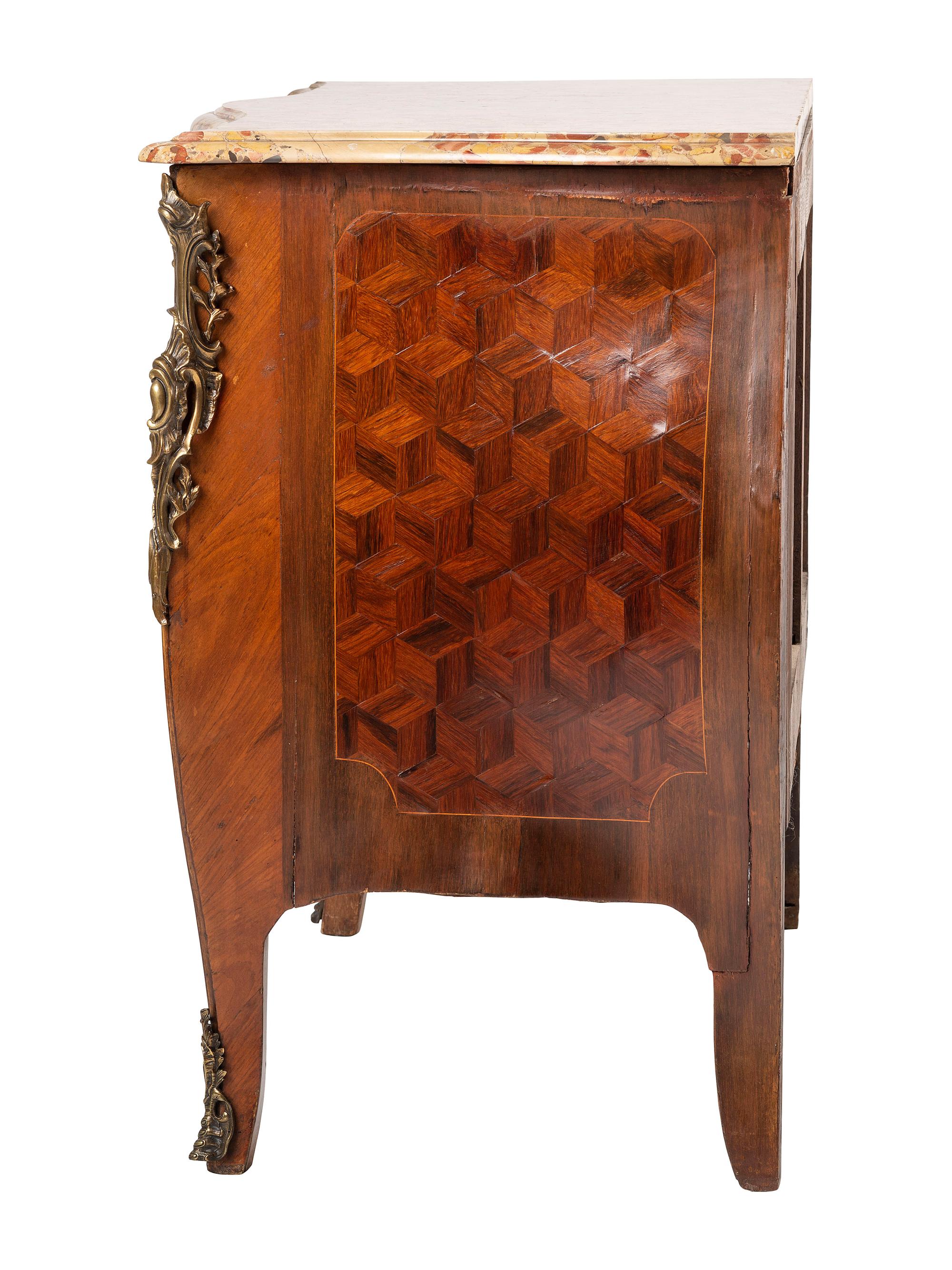 A Régence Style Bronze Mounted Marble Top Marquetry Commode