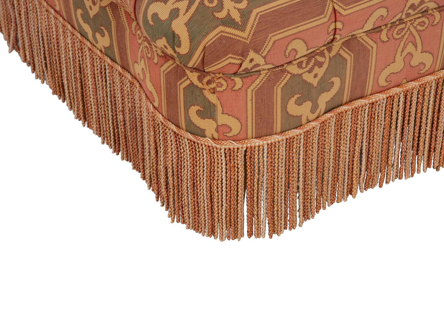 An Upholstered Button Tufted Ottoman with Skirt