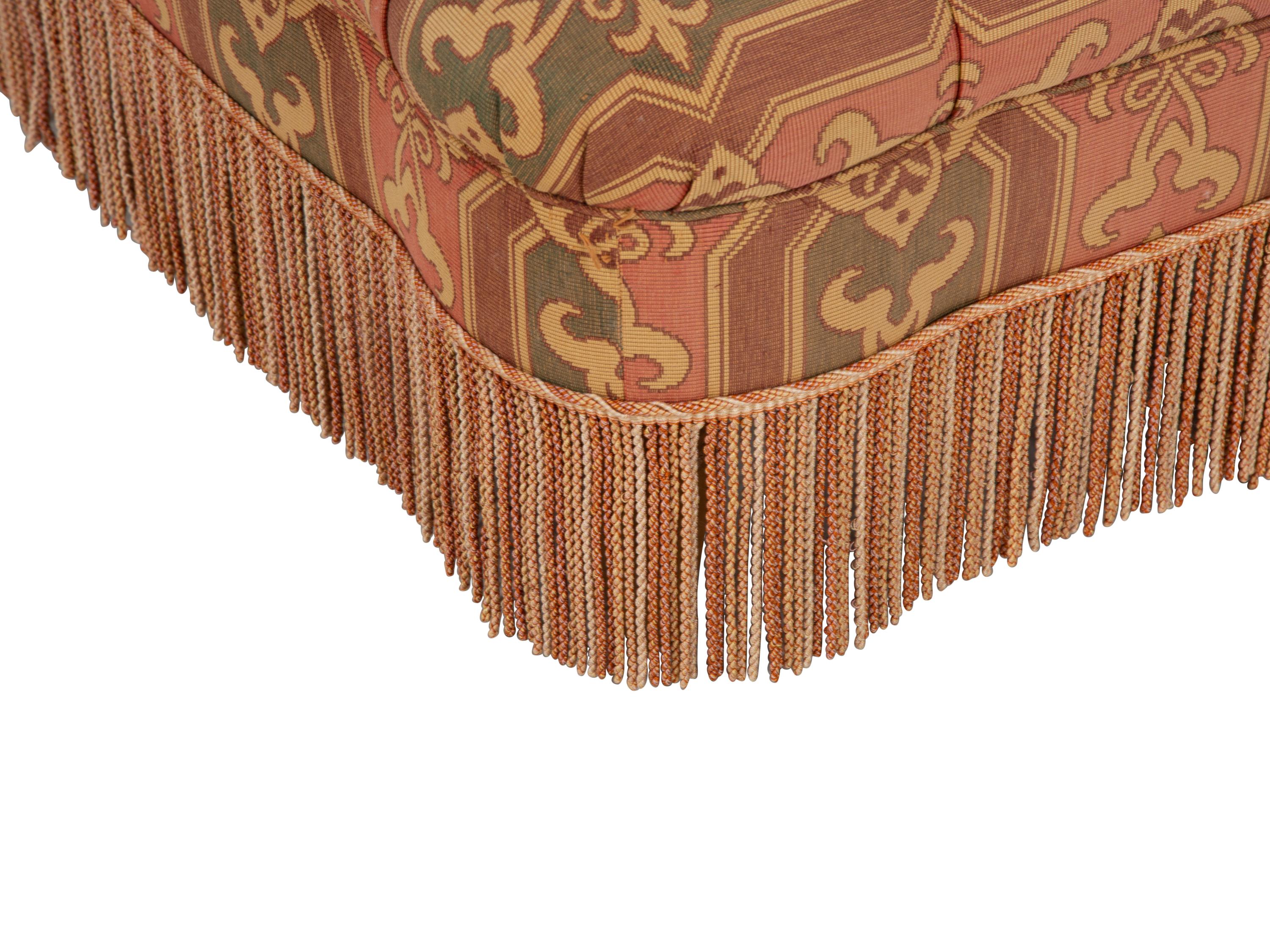 An Upholstered Button Tufted Ottoman with Skirt