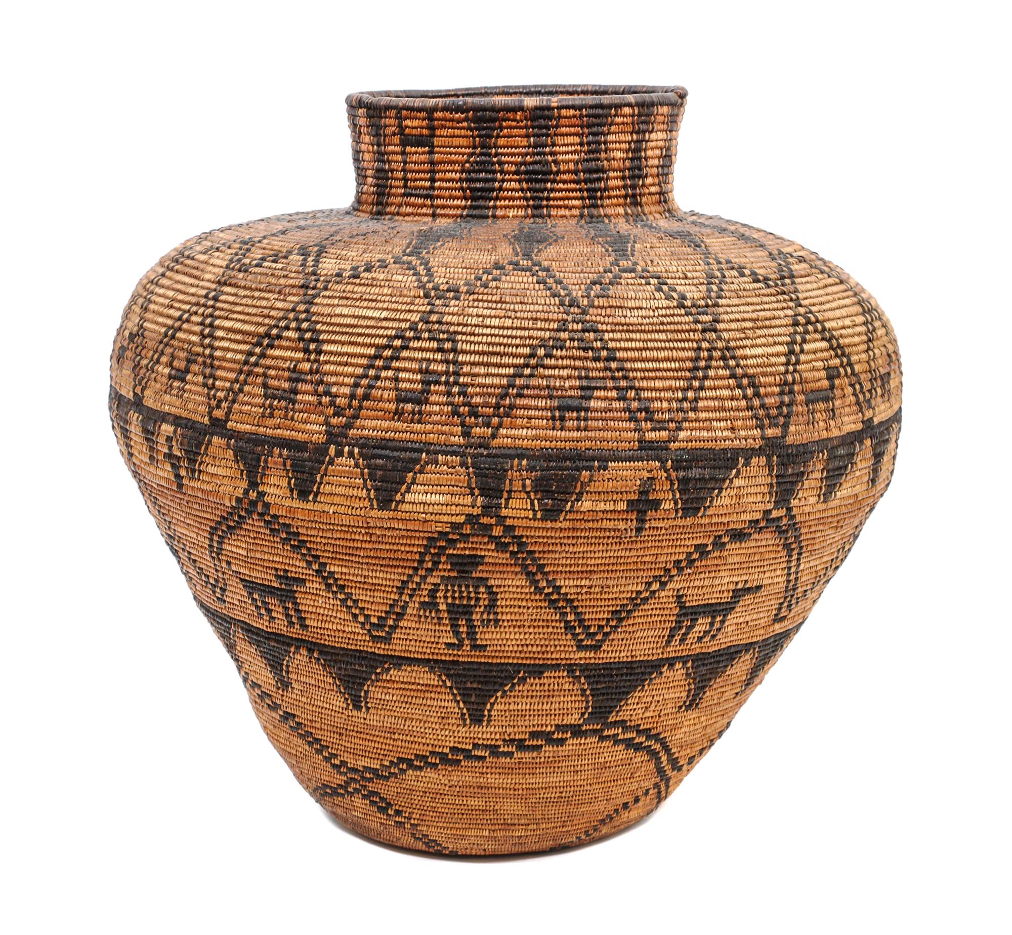 A Western Apache Pictorial Basket Height 21 1/2 x diameter 24 inches.