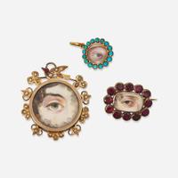 A Georgian "Lover's Eye" brooch and two pendants early 19th century