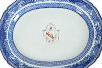 A Pair of Chinese Export Porcelain Armorial Platters Raised on Later Mahogany Stands