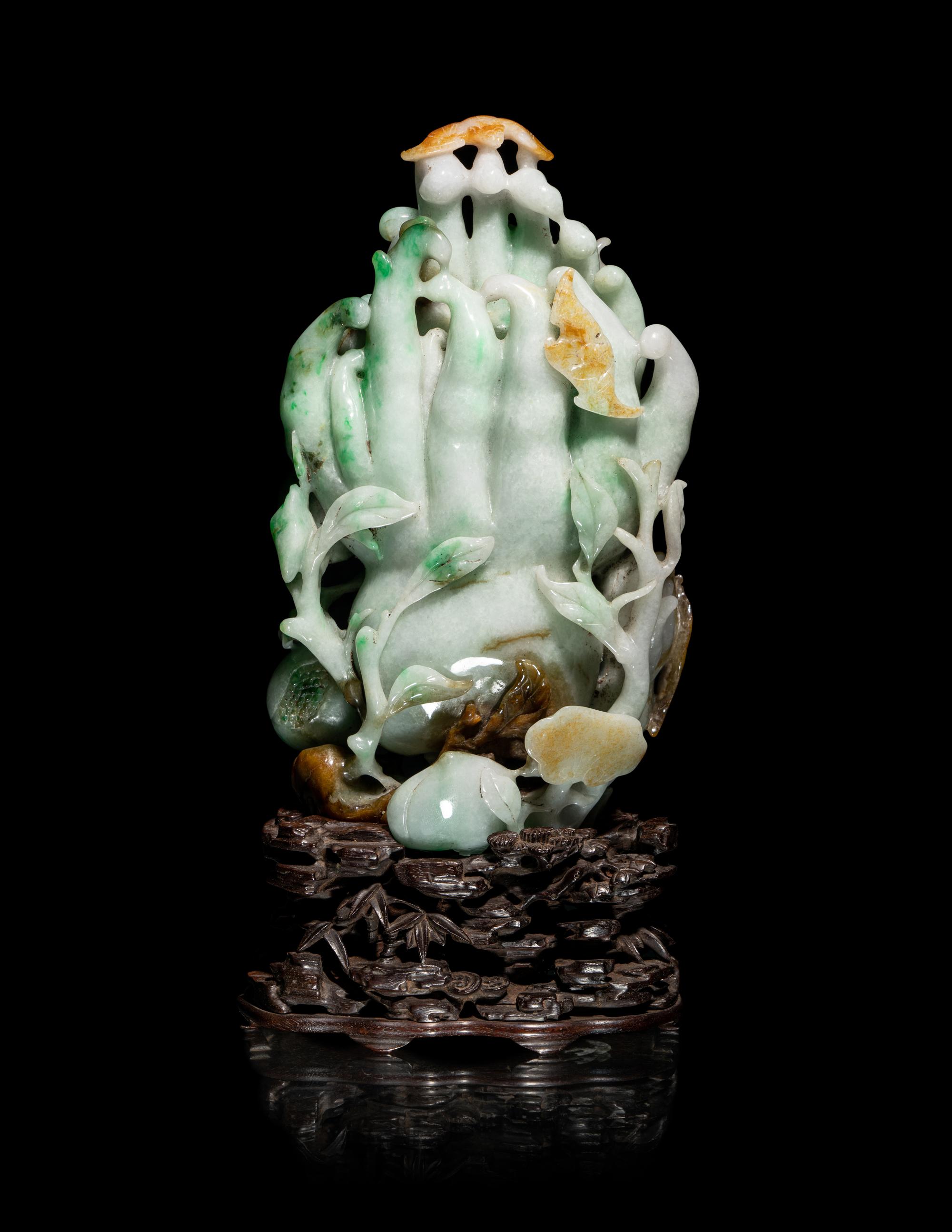 A Chinese Apple Green and Russet Jadeite Carving of Buddha's Hand Citron