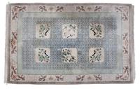 An Asian Design Wool Rug 3 feet 8 inches x 2 feet 5 1/2 inches. — 20TH CENTURY