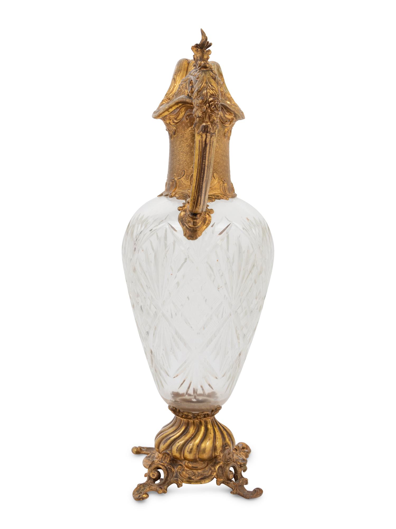 A Gilt Metal Mounted Cut Glass Claret Jug
