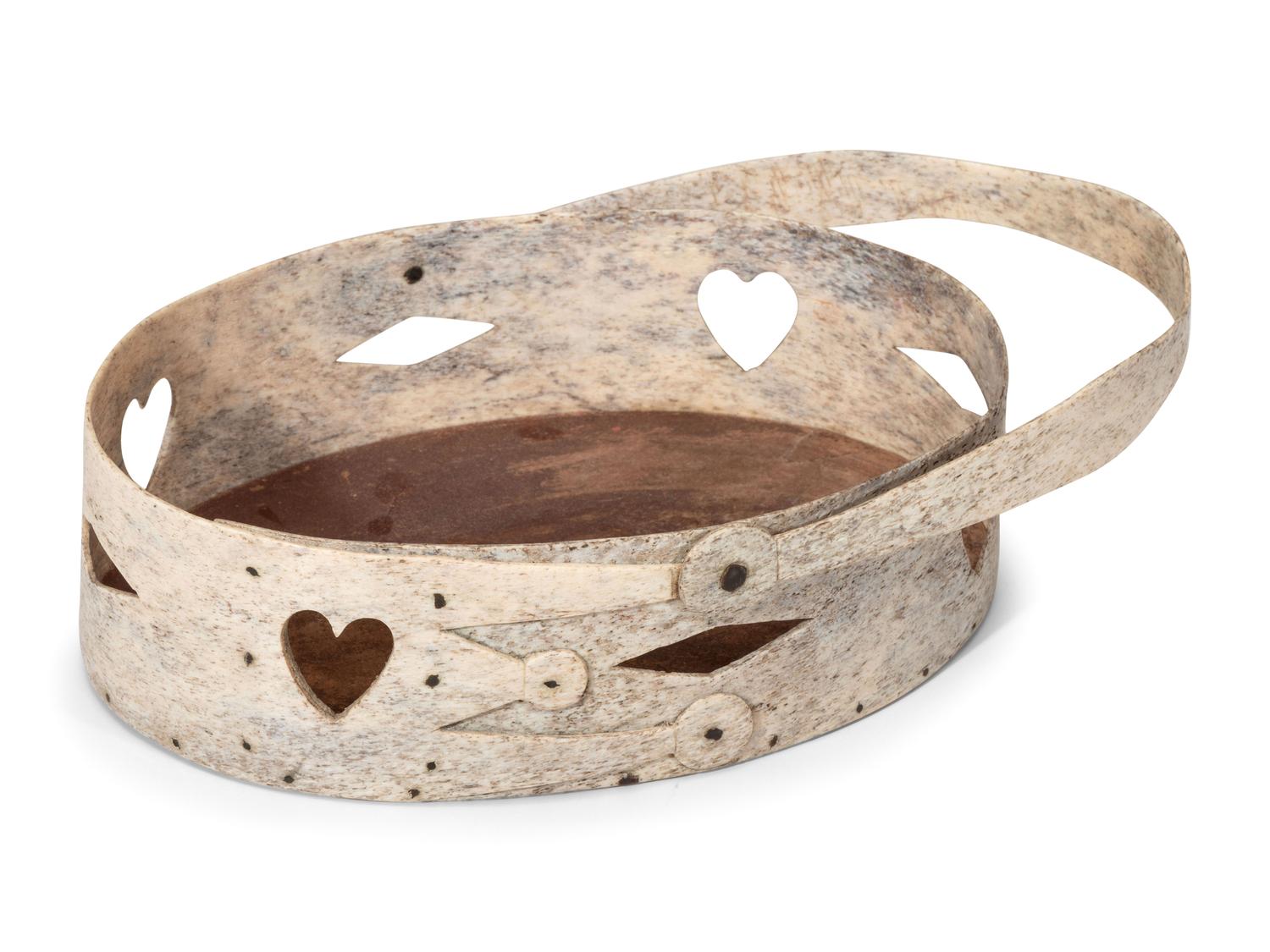 A Carved and Pierced Whale Bone Swing-Handle Basket