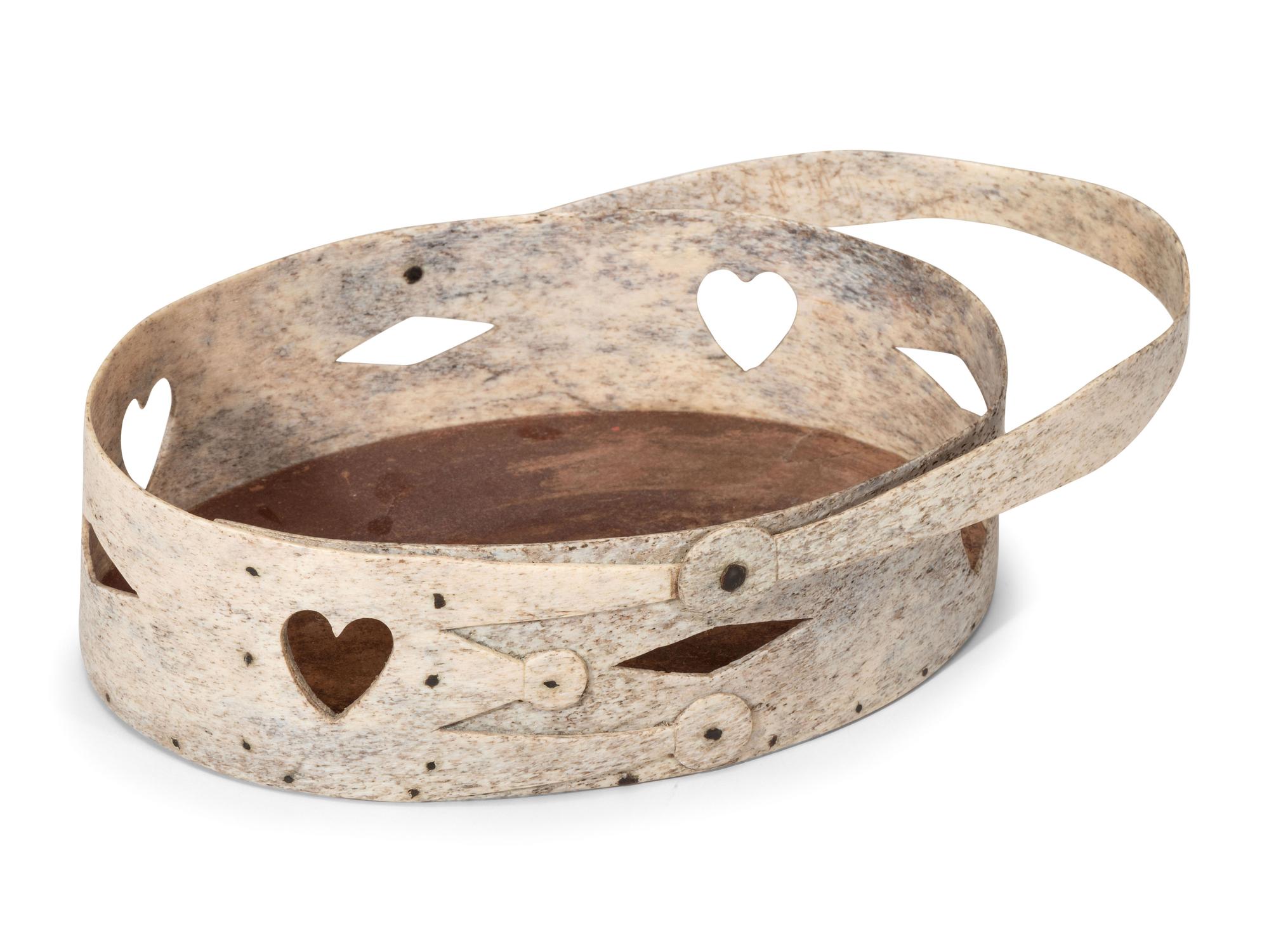 A Carved and Pierced Whale Bone Swing-Handle Basket