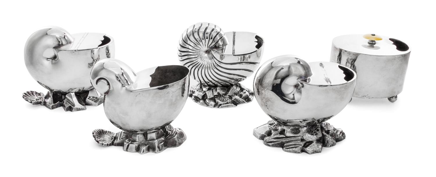 A Group of Five Silver Plate Spoon Warmers, , four in the form of nautilus shells, together with a typical example.
