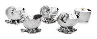 A Group of Five Silver Plate Spoon Warmers, , four in the form of nautilus shells, together with a typical example.