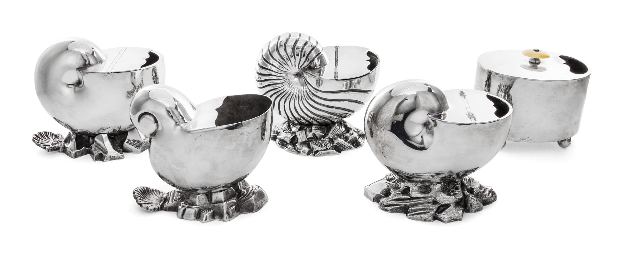 A Group of Five Silver Plate Spoon Warmers, , four in the form of nautilus shells, together with a typical example.