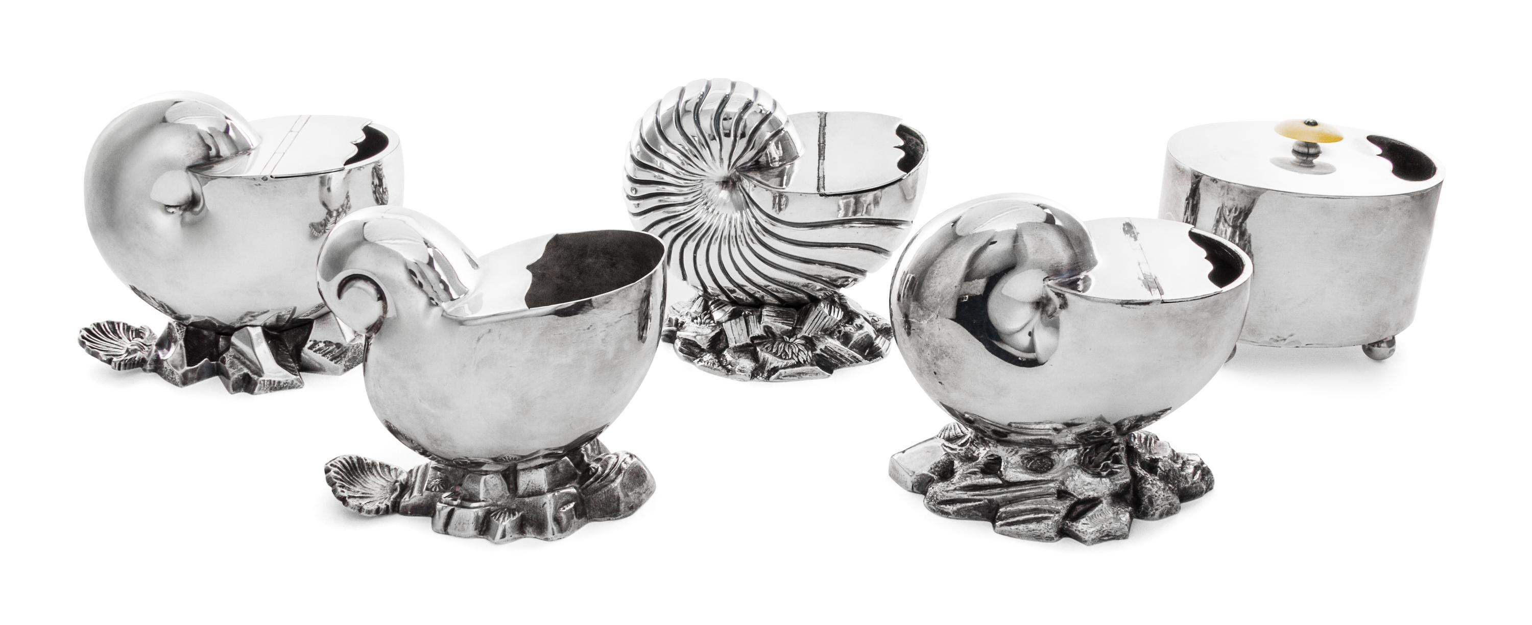A Group of Five Silver Plate Spoon Warmers, , four in the form of nautilus shells, together with a typical example.